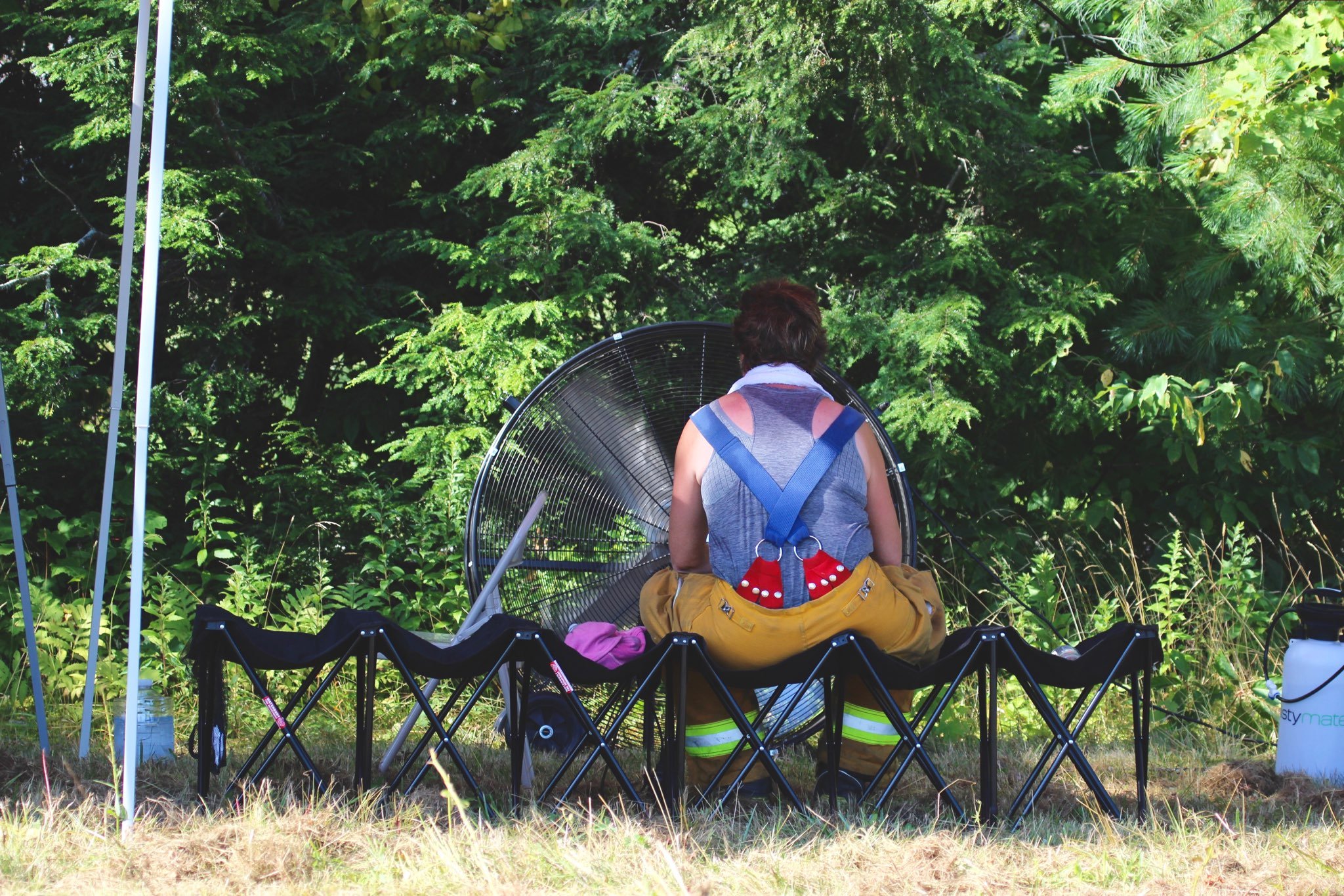   Battalion Chief Sally Dillon cools off in front of a large fan. Photo by René Morse  