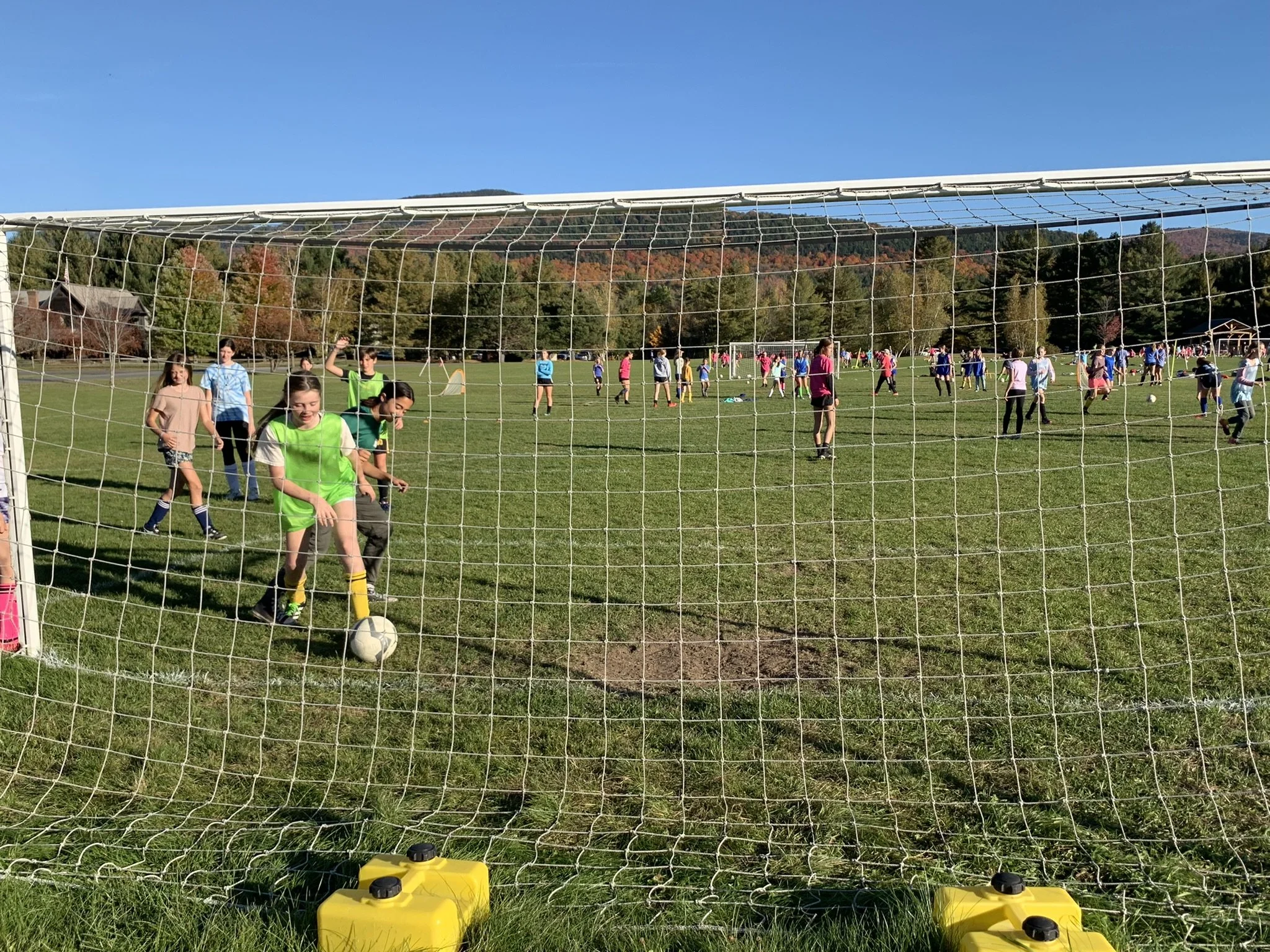  Players are organized into groups by age with several of the high school players leading each exercise.  