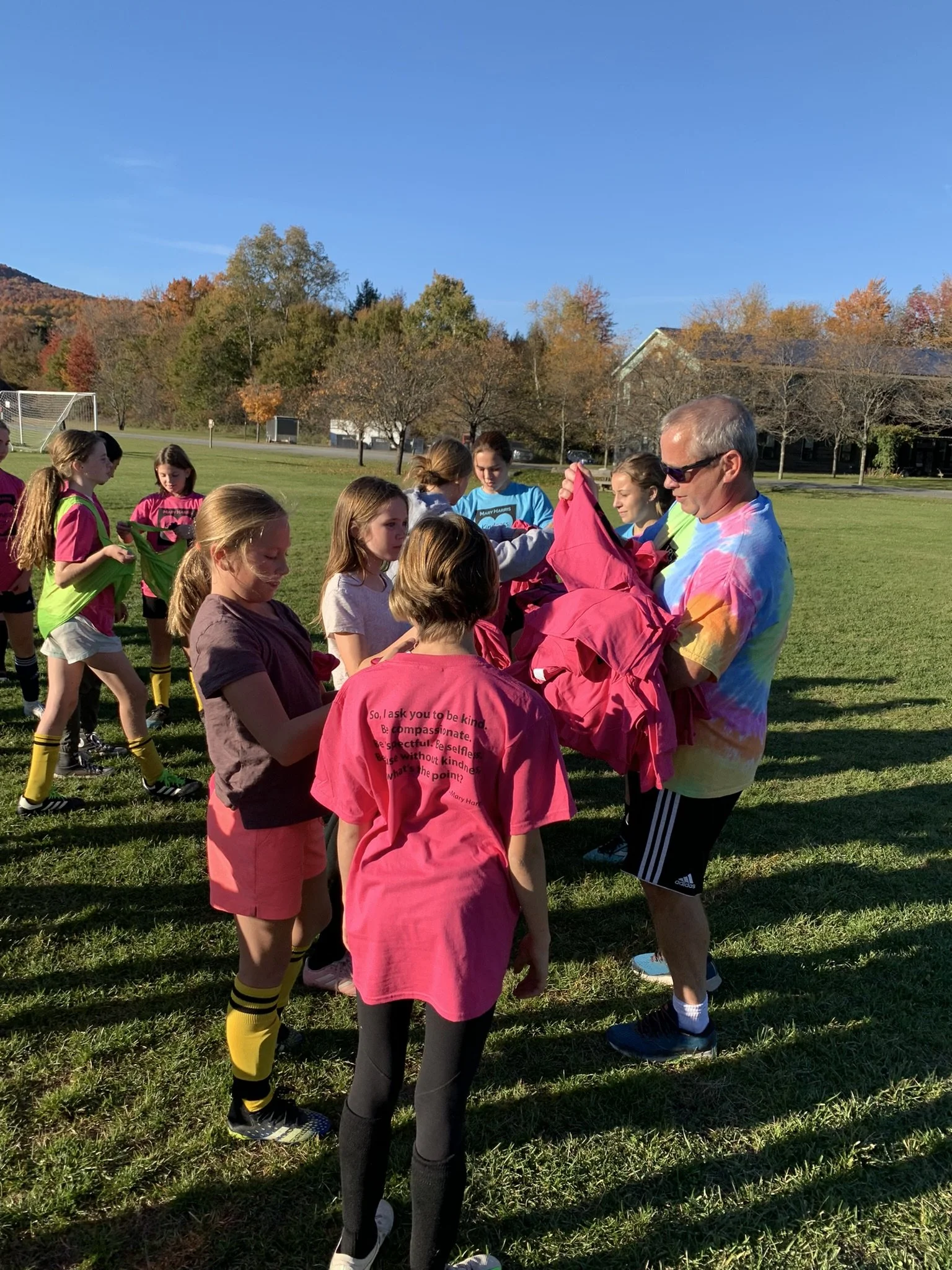  Harwood Varisty Coach Mike Vasseur hands out t-shirts.  