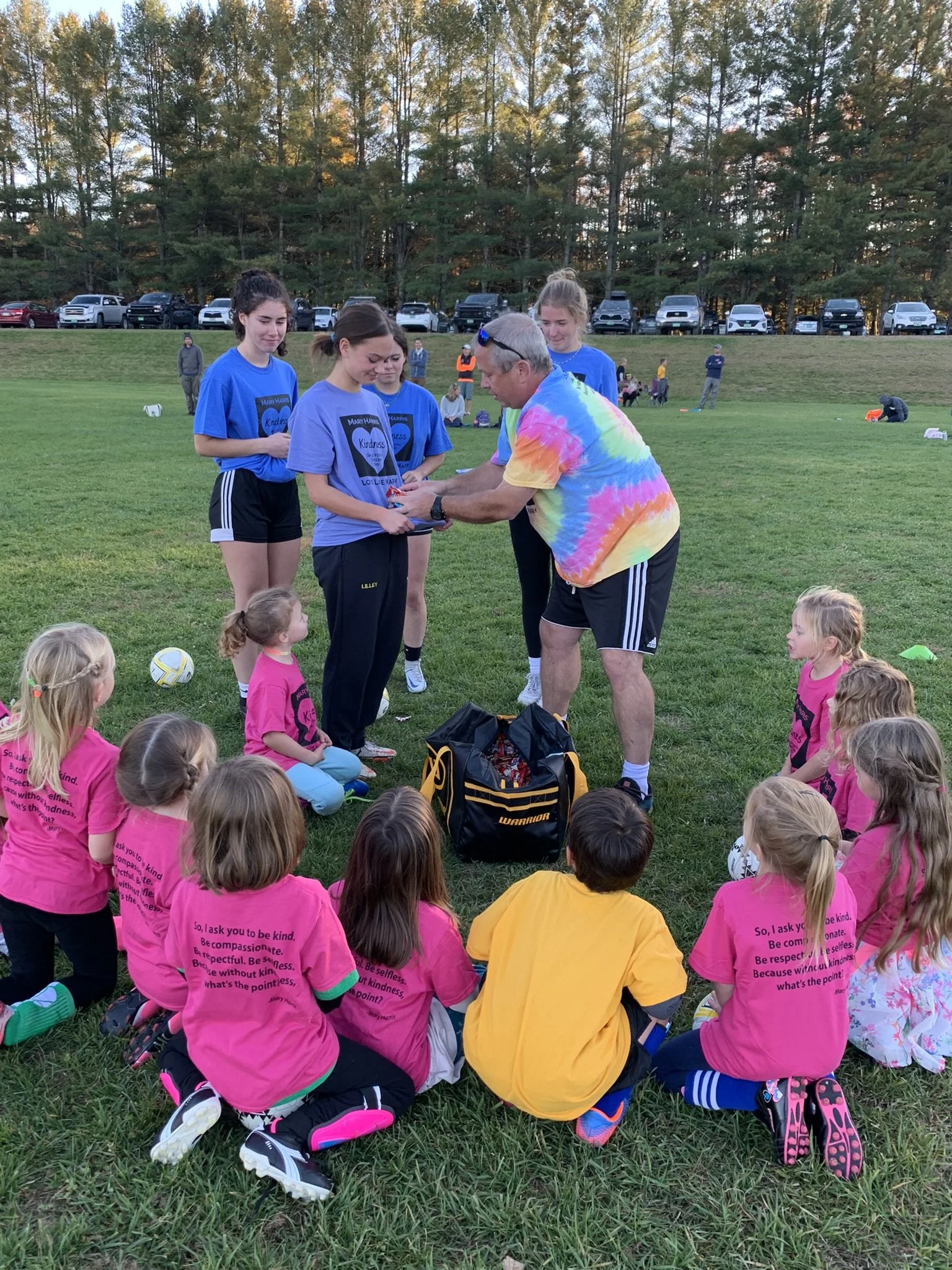  Each group gets candy in a running game of tag. Coach Mike Vasseur distributes treats to the high school players.  