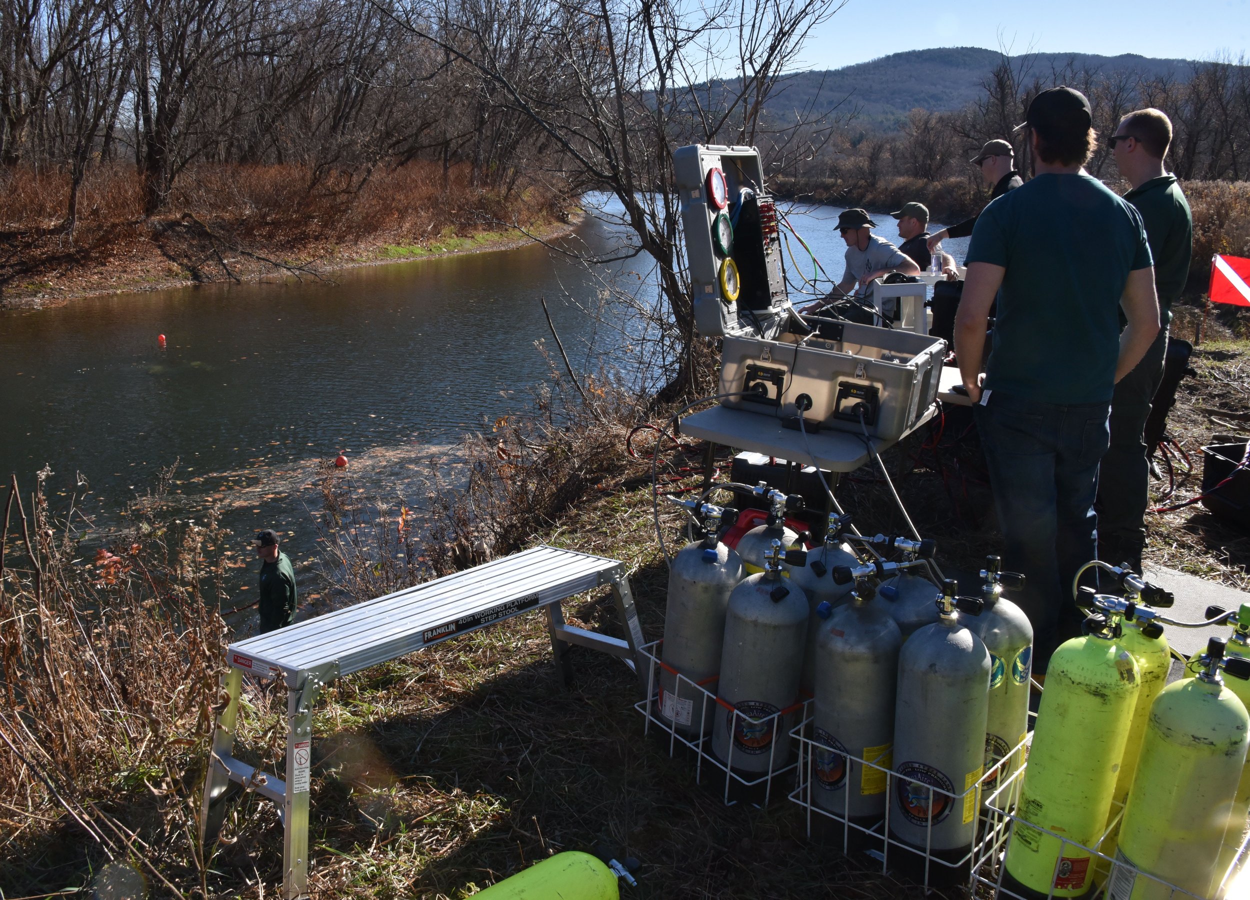  Dive team members are set up on the bank above the spot where Donald Messier’s truck was recovered and where divers will work for the day. Photo by Gordon Miller 