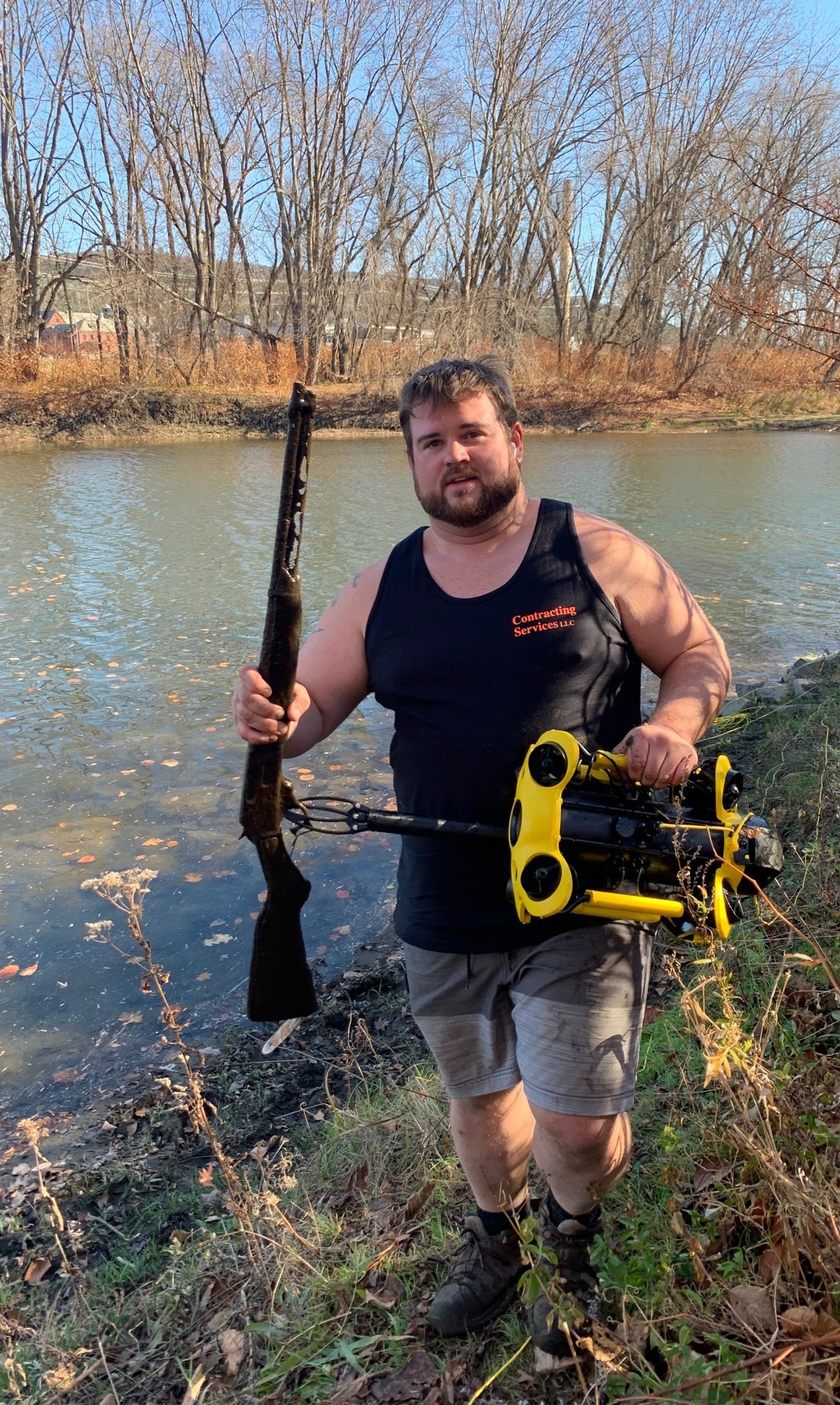  Tim McDonald retrieves a rifle located on the river bottom using the drone which has a maneuverable arm. Photo by Lisa Scagliotti 