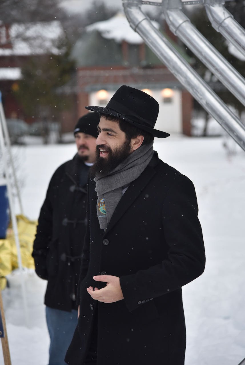   Rabbi Baruch Simon leads the ceremony at Rusty Parker Park marking the start of Chanukah, the Jewish festival of lights. Simon organized the first public menorah display in Waterbury. Photo by Gordon Miller  