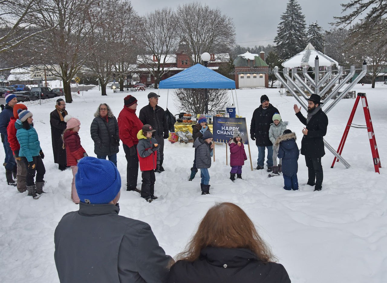   About 30 people gather in Rusty Parker Park on Dec. 18, the first day of Chanukah, for a menorah lighting ceremony. Photo by Gordon Miller  