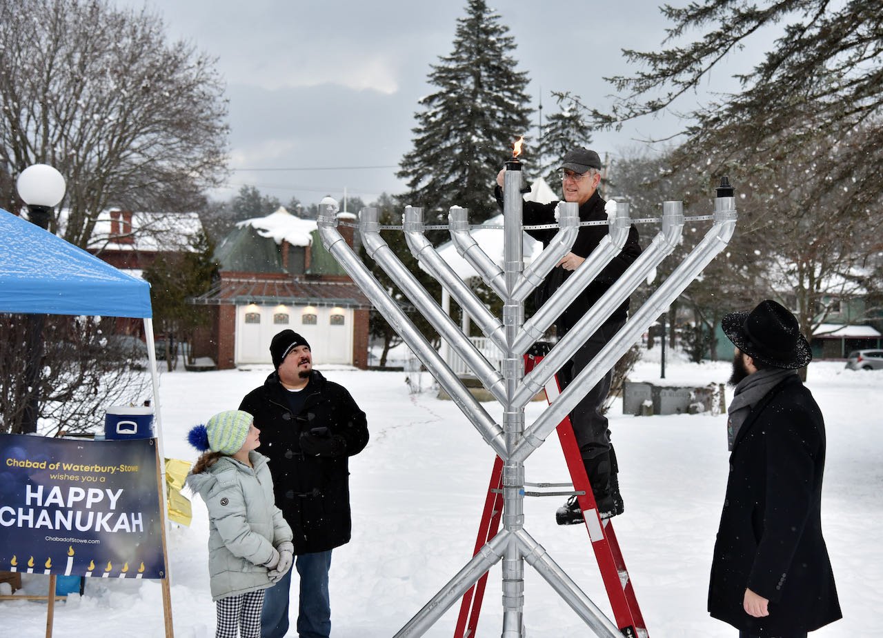   Municipal Manager Bill Shepeluk lights the first light on the menorah. Photo by Gordon Miller  