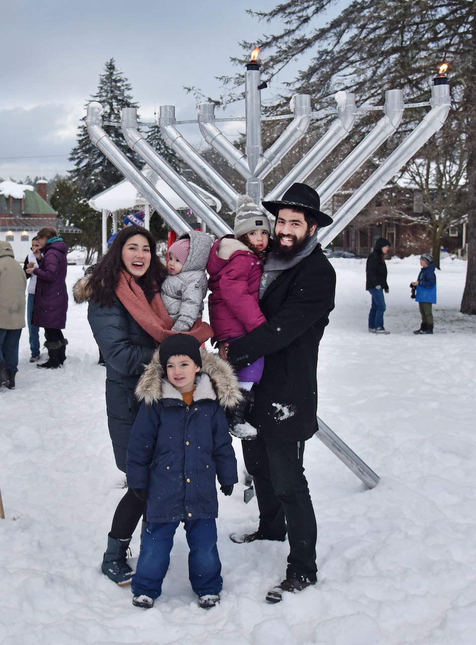   Sarah and Rabbi Baruch Simon and their family at the menorah lighting ceremony on Dec. 18. Photo by Gordon Miller  
