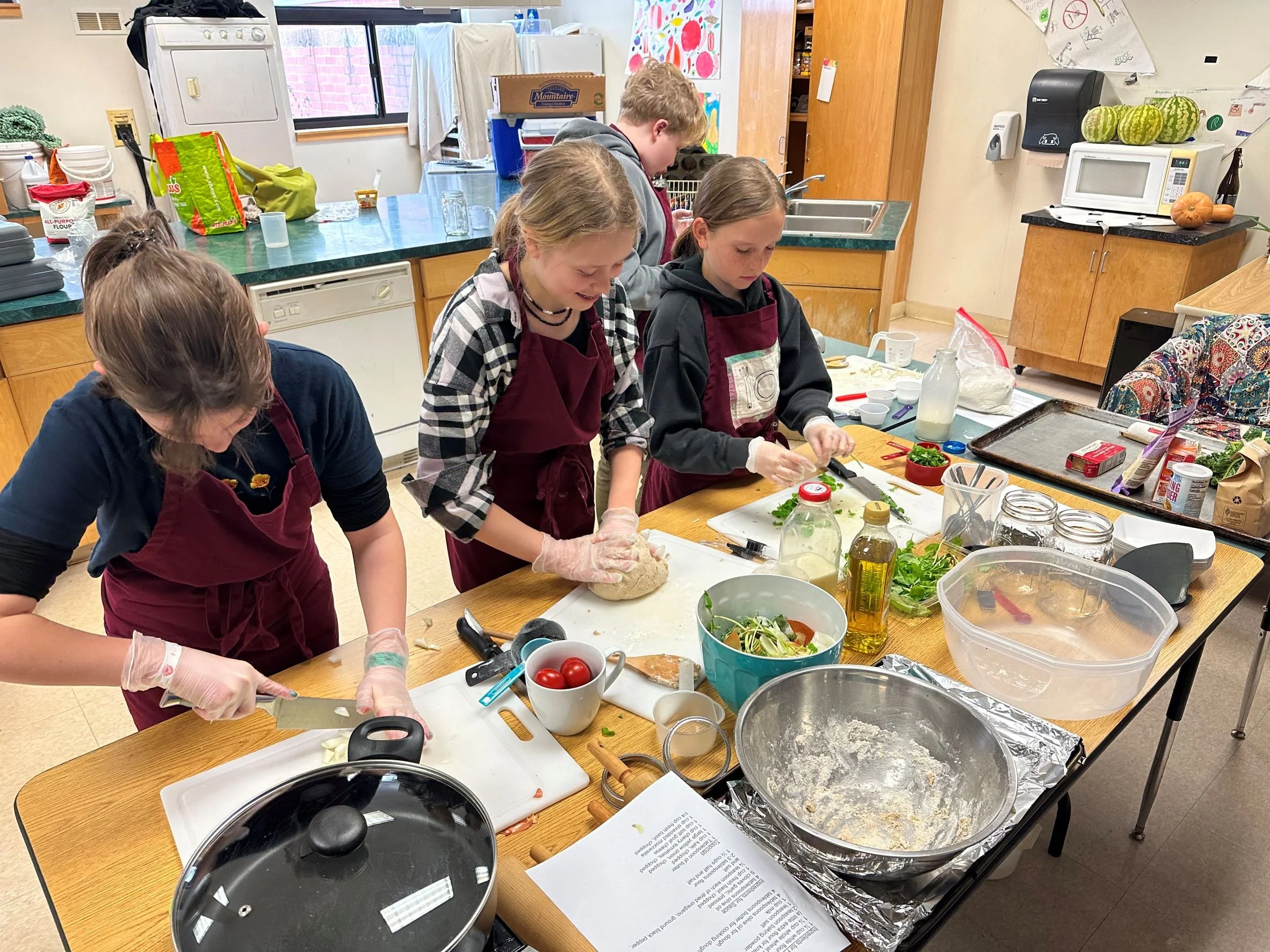   Sixth and seventh graders practicing prepping the Fancy Farm Flatbread. Photo by Erika Dolan  