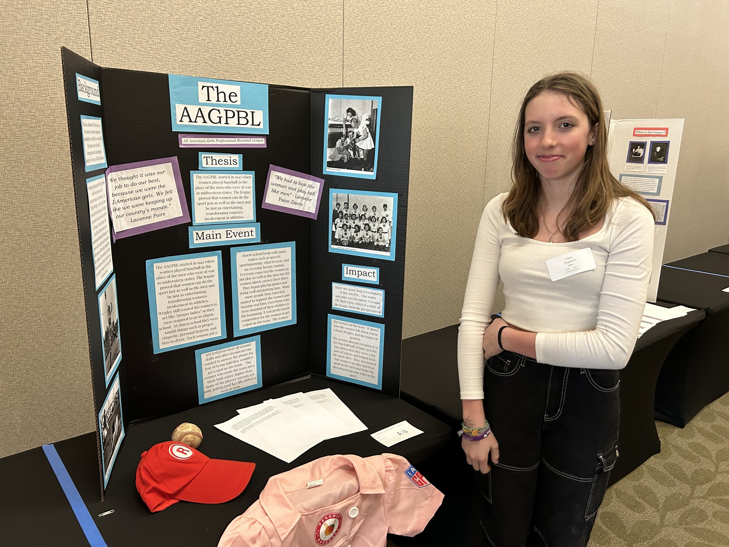   Harwood Middle School student Claire Nagurney with her exhibit, "The AAGPBL: Frontier Women in Baseball." Photo by Becky Allen  