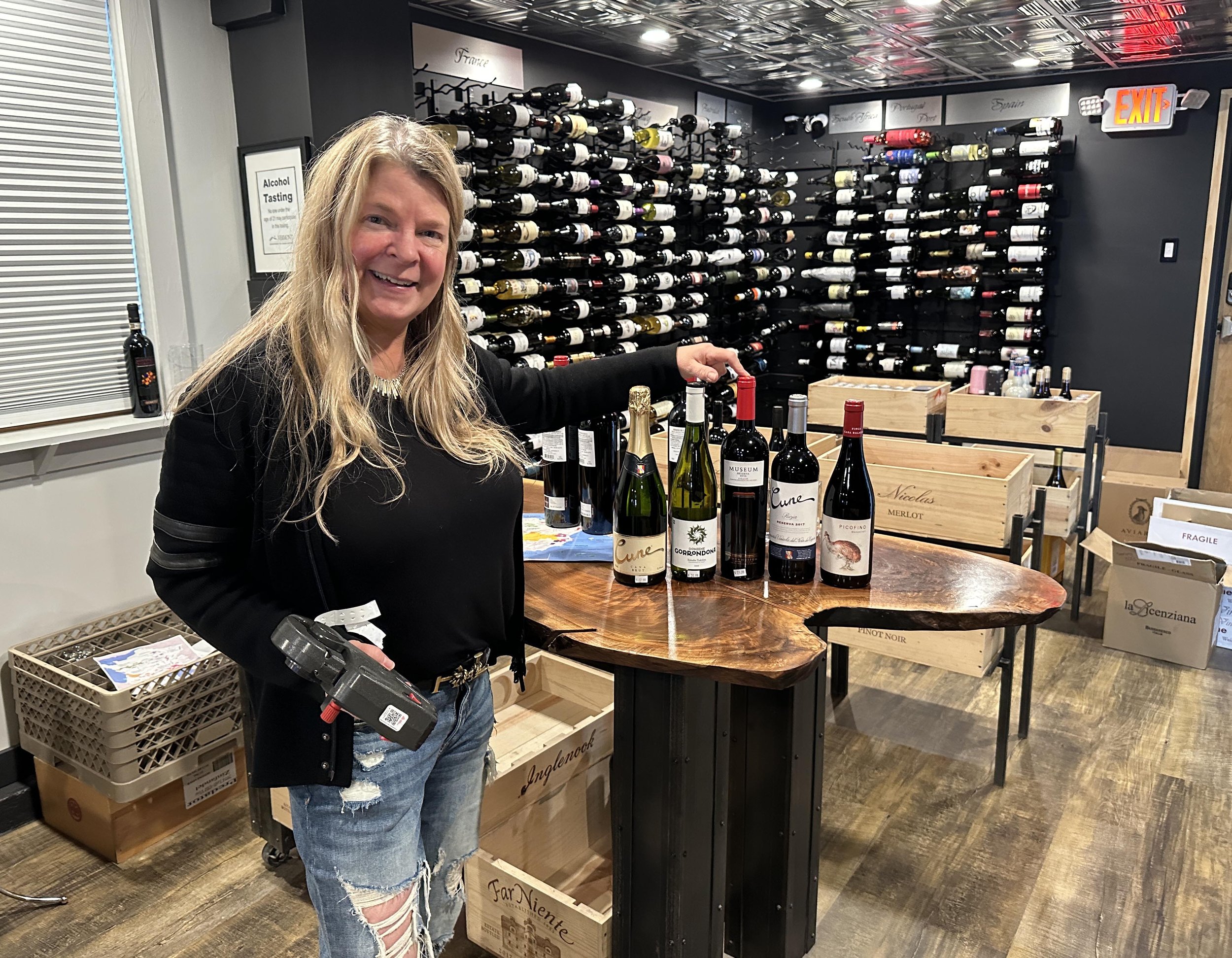  Wine Vault owner Anastasia Kohl stocks fresh inventory as her shop gets back on its feet from the flood. Photo by Gordon Miller 