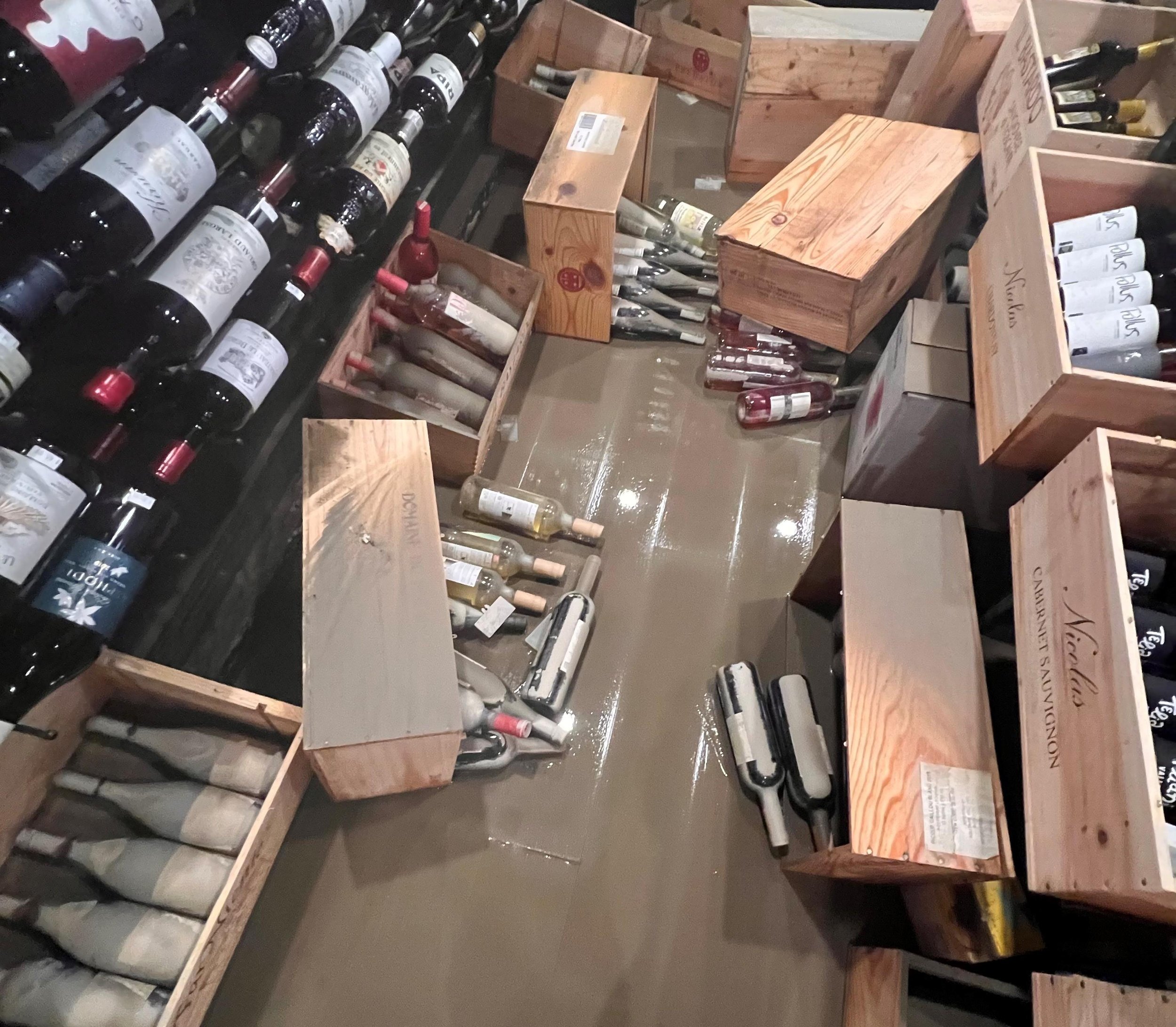  A thin layer of river residue coats the low-lying inventory at the Wine Vault after the water recedes. Courtesy photo 