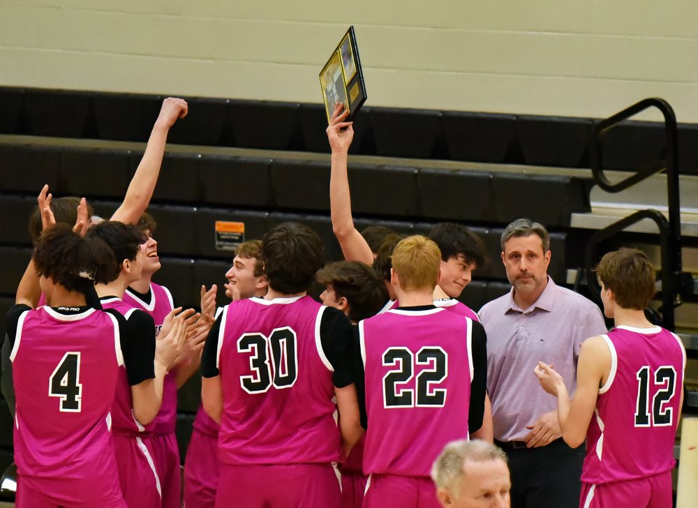  the team with Coach Jay Bellows (right) celebrates during a brief time out. Photo by Gordon Miller  