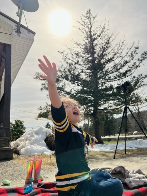   Riley Morin celebrates the eclipse. Photo by Jo Wood  