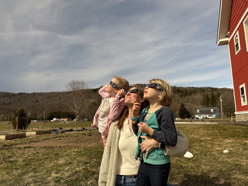   Laura Hardie and kids take in the eclipse along Rt. 2 in Waterbury.   