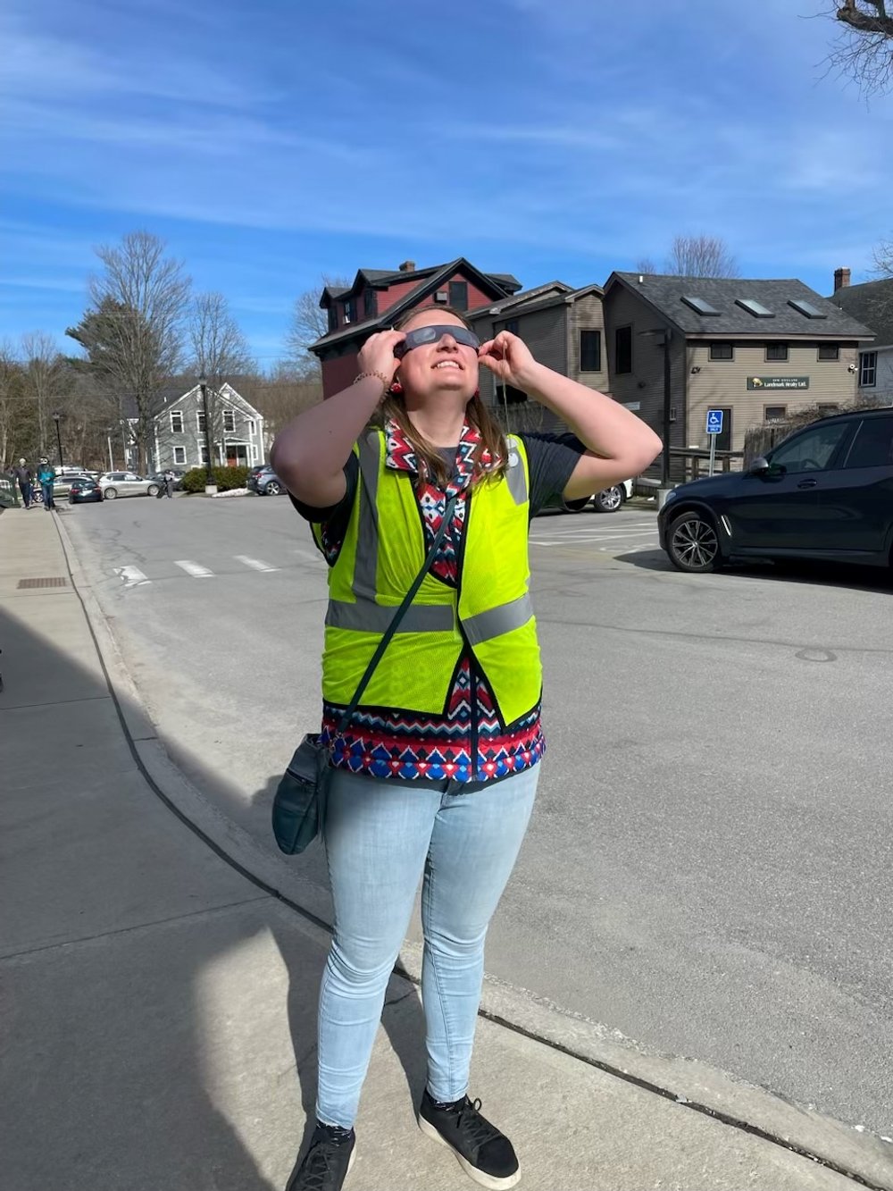   Recreation staffer Katie Mandych takes in the eclipse on a very extraordinary work day. Photo by Katarina Lisaius  