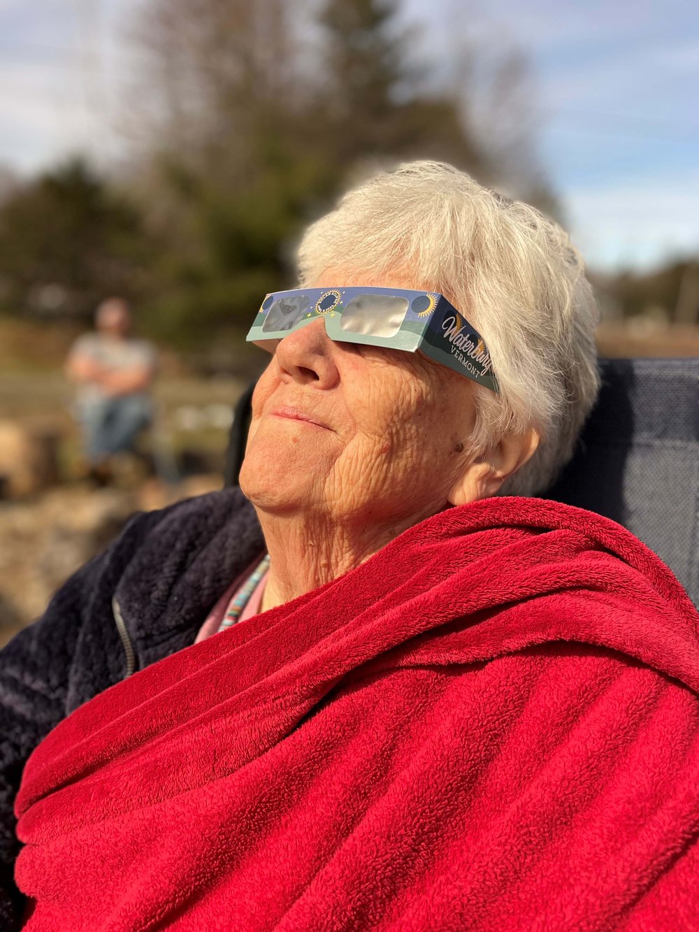   Sharon Fuller takes in the eclipse in Waterbury Center. Photo by Bethany Fuller  