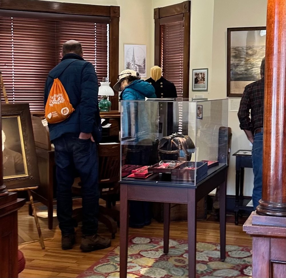   People check out historical artifacts about Dr. Henry Janes at the history center. Photo by Cheryl Casey  