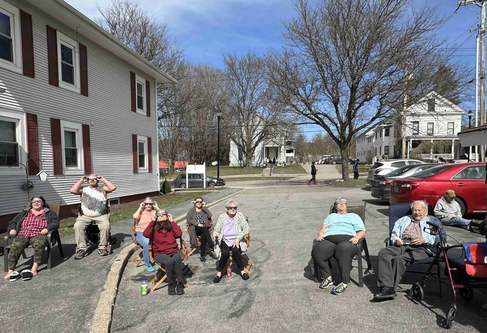   Residents from the Wells Apartments enjoy the view from their side yard. Photo by Lisa Scagliotti  