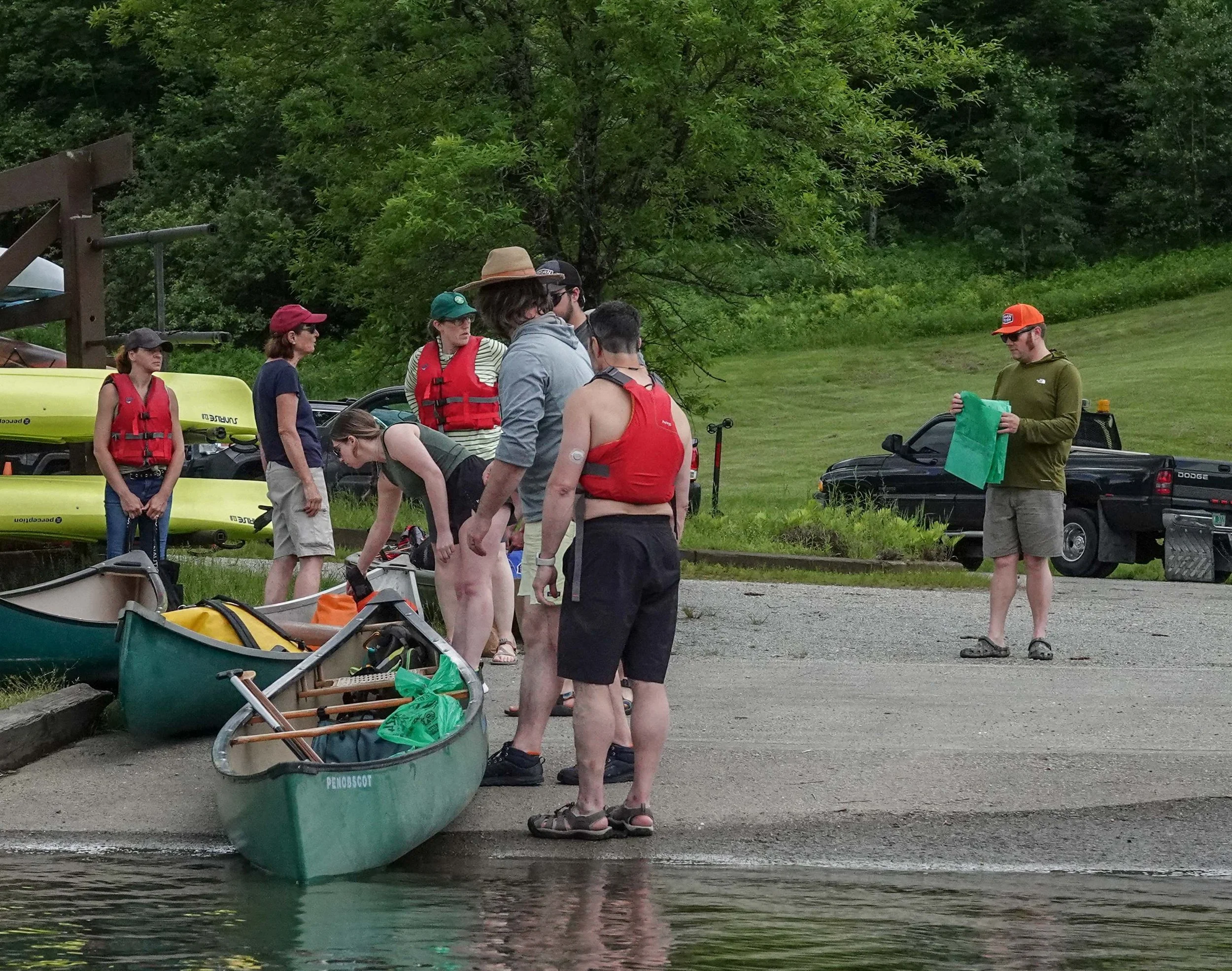   Volunteers prep with supplies to collect trash before heading onto the water. Photo by Sheila Goss  