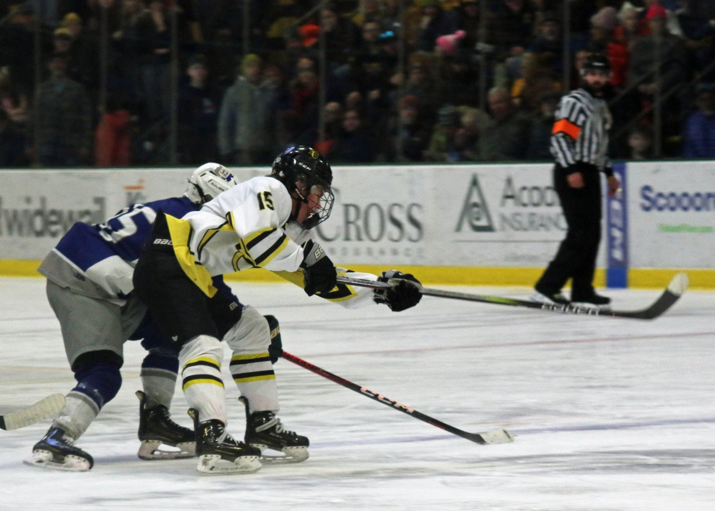  Cooper Browe takes a shot with a U-32 defender on his skates. Photo by Brian Larrabee 