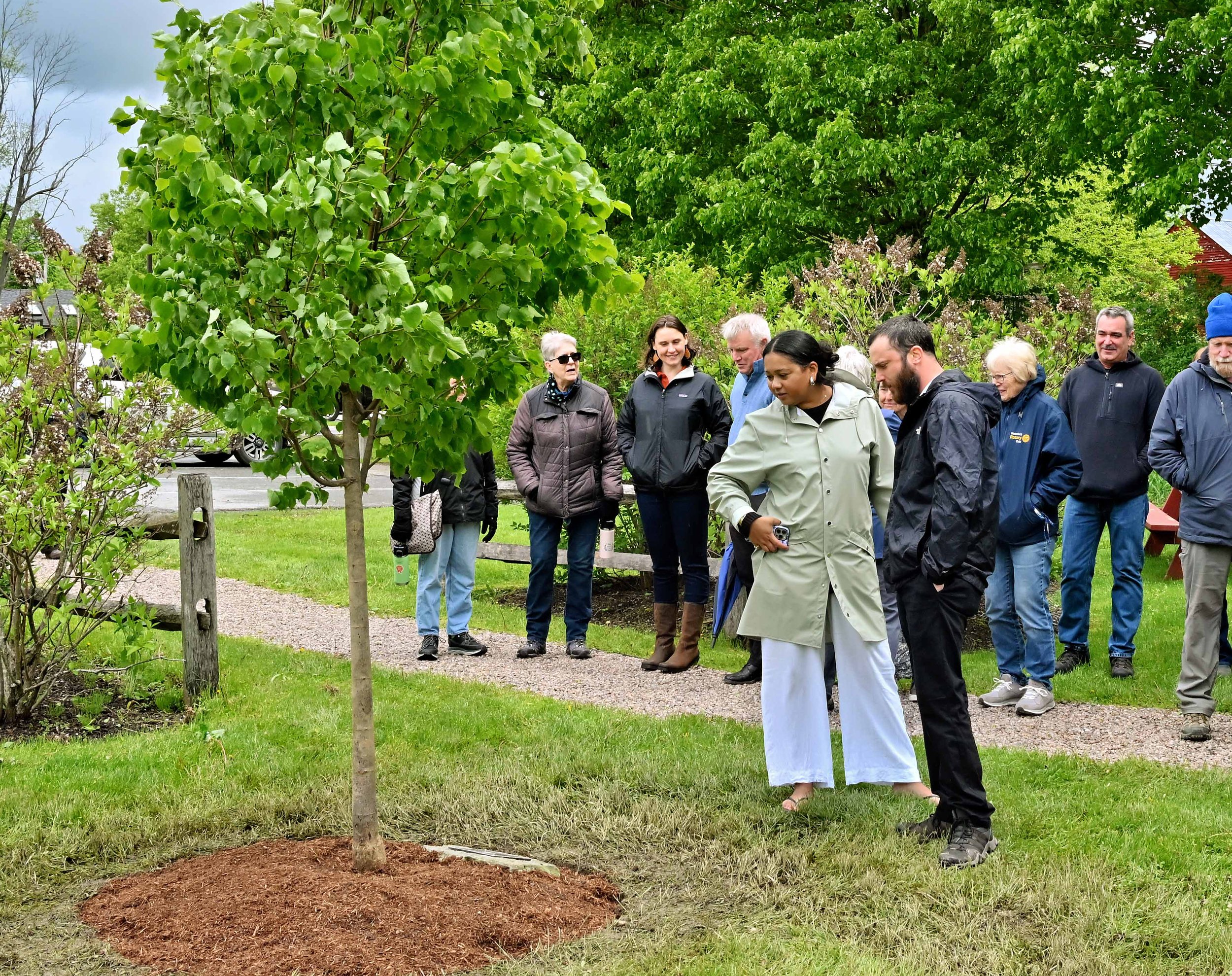 Steve Lotspeich's daughter Yana and her partner read the inscription on the dedication plaque. Photo by Gordon Miller