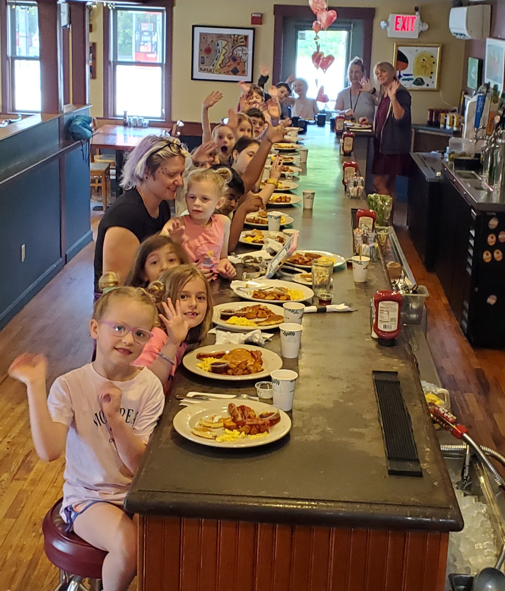 Teacher Amy Bryant (far right) and her class at Maxi's counter. Courtesy photo