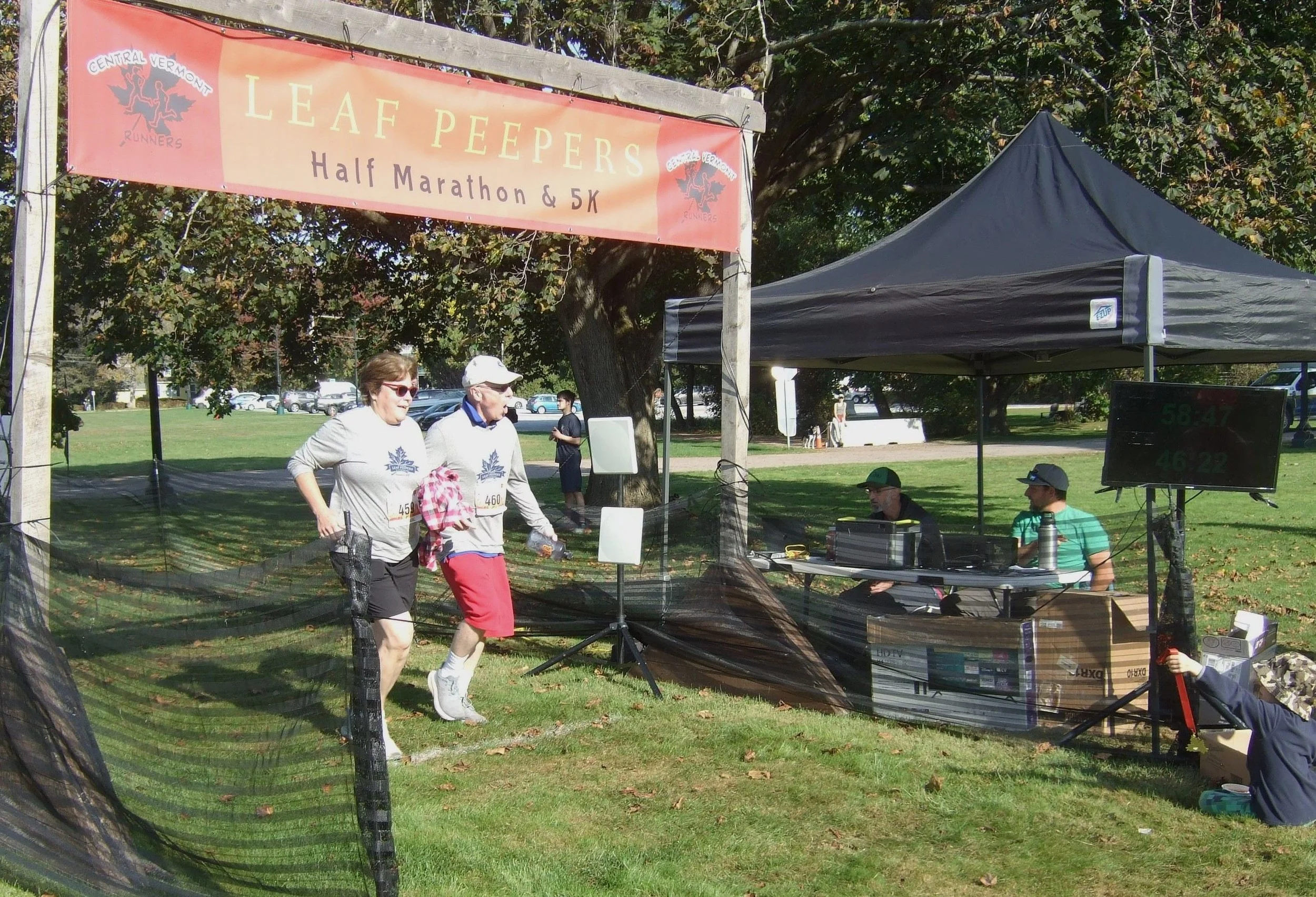  Lynn and Mitch Page of Newington, Connecticut, cross the 5K finish. They each placed 9th in their respective 60-69 age category. Photo by Sarah Andrews  