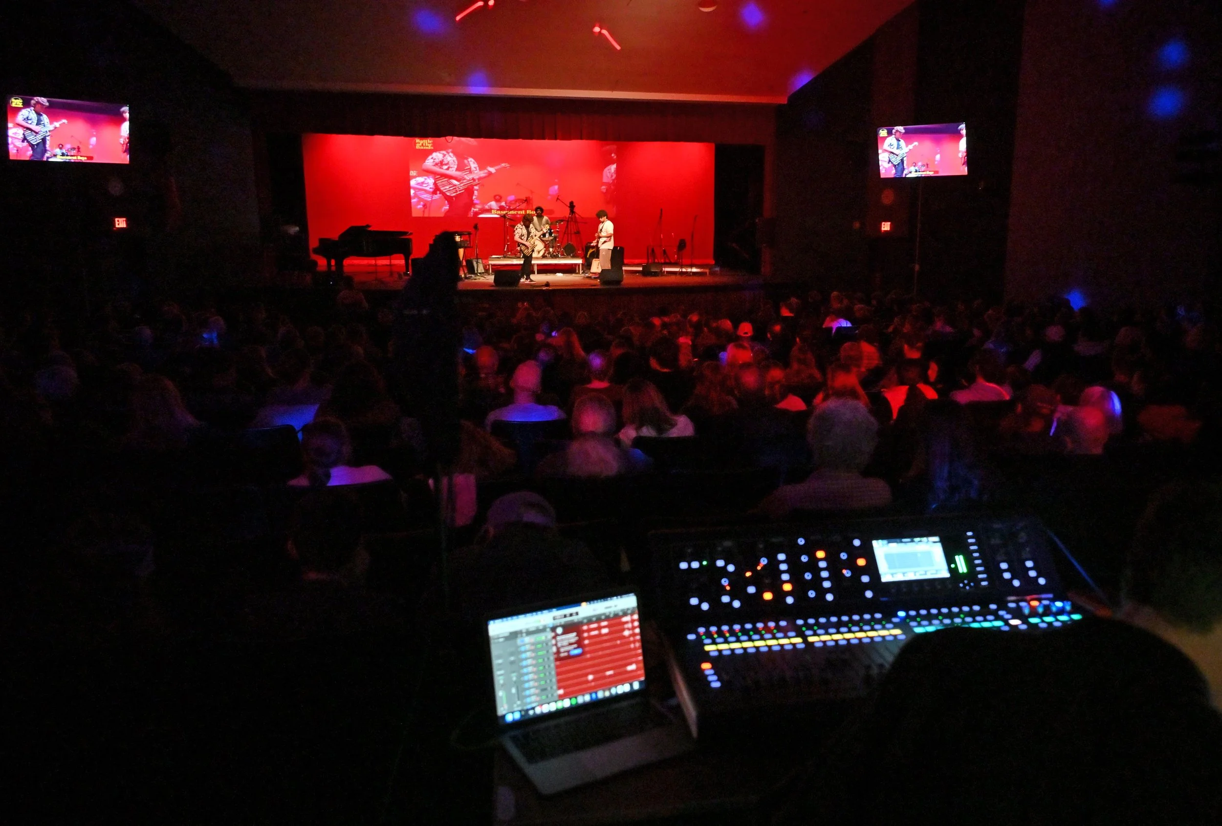  The view from the soundboard. Harwood's auditorium got extra video screens stage side for the event. Photo by Gordon Miller 