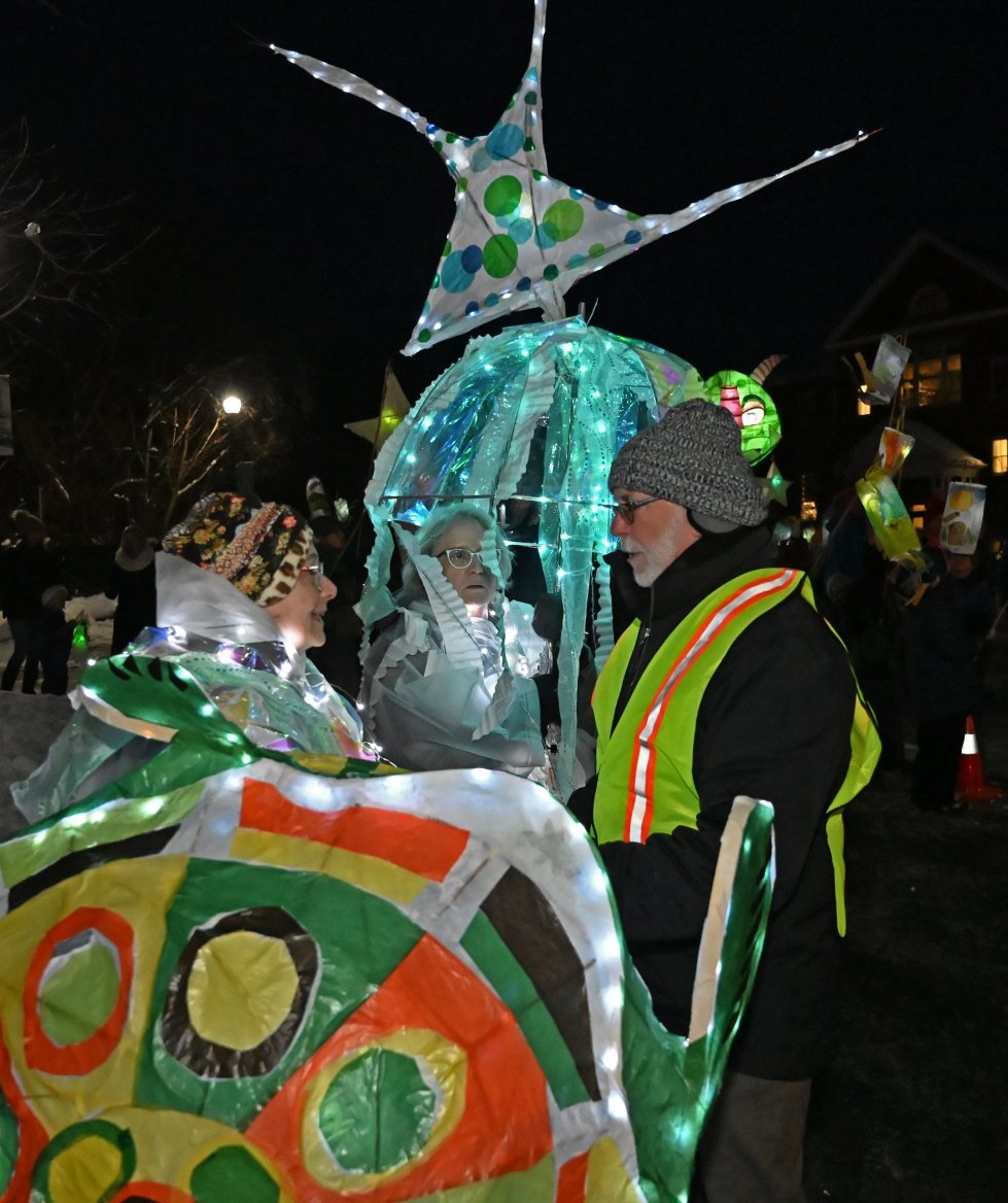   Parade organizers Mame McKee (left), MK Monley (center) and Don Schneider (right) at the start of the 2024 River of Light parade. Photo by Gordon Miller&nbsp;       