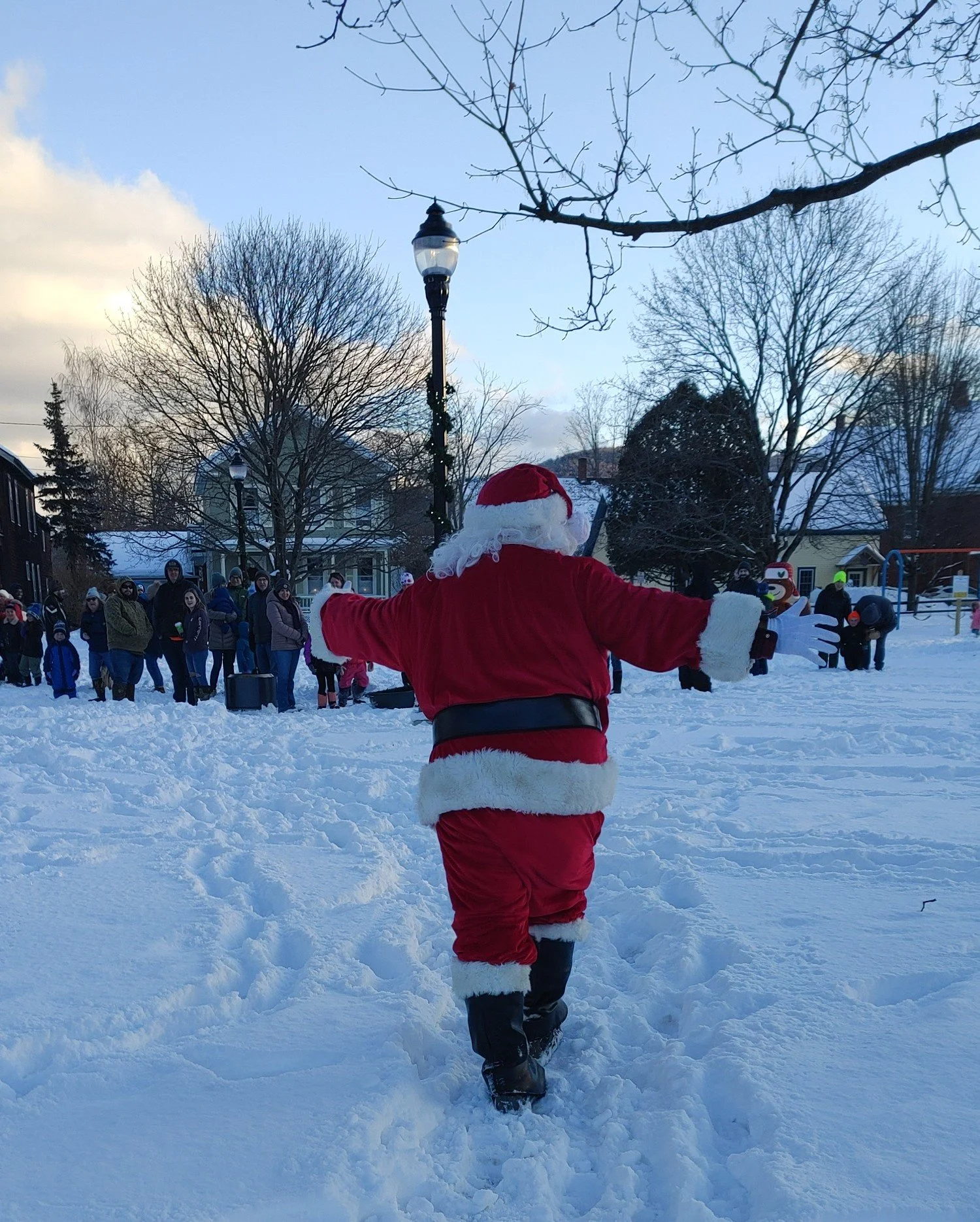  After his last visitor, Santa heads across the park for the menorah lighting ceremony. Photo by Debbie Bard 