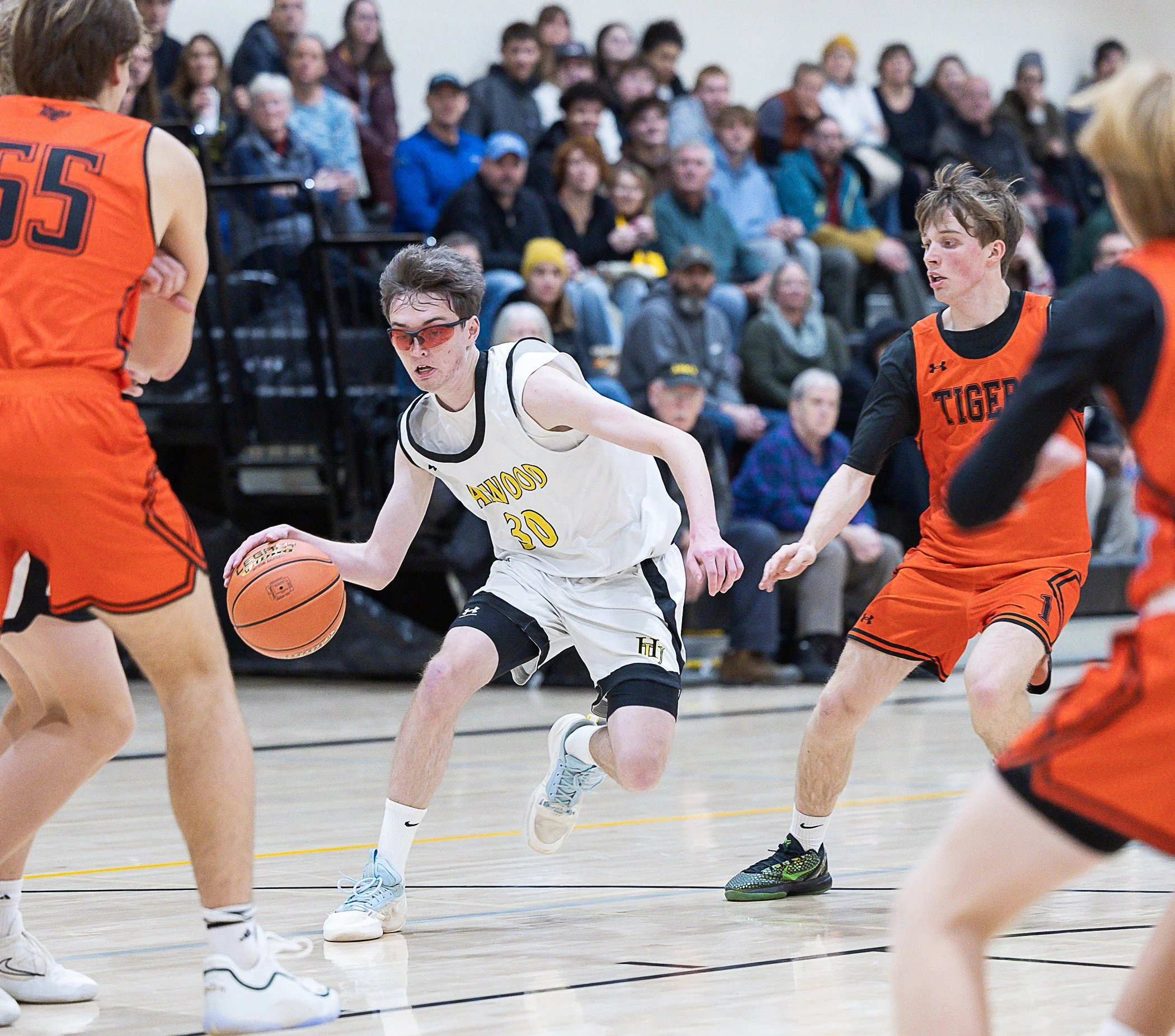   Harwood senior Alec Sands controls the ball through the Tigers' defense.&nbsp;Photo by Sarah Milligan  