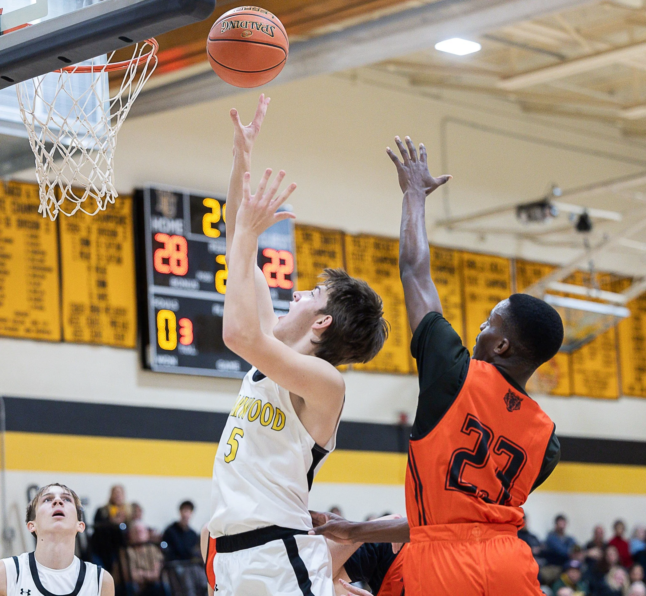   Harwood junior Sawyer Pekarski fends off Middlebury at the net.&nbsp;Photo by Sarah Milligan  