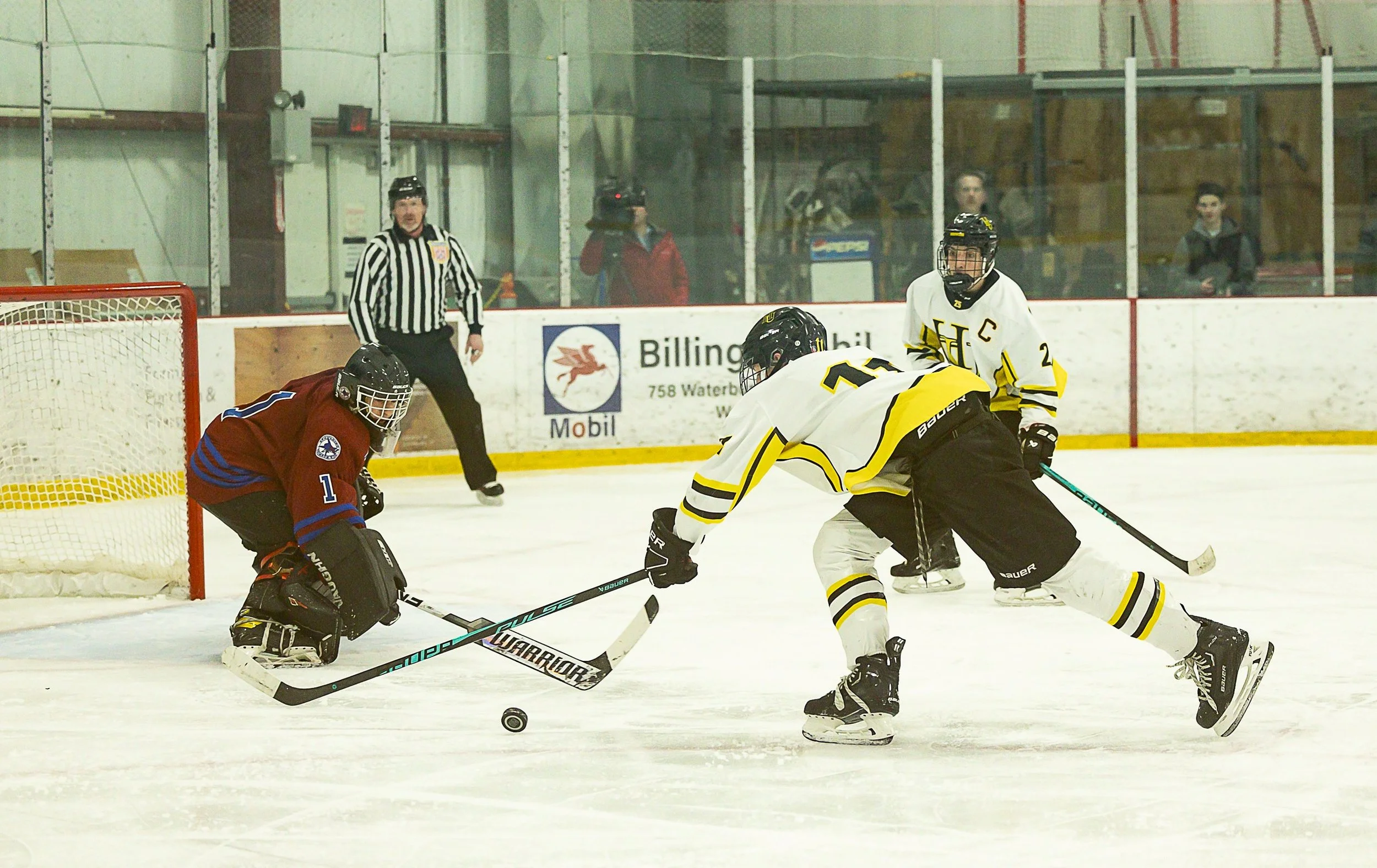  Spaulding goalie Ethan Fortin blocks a shot by Harwood’s Griffin Nelson. Photo by Michaela Milligan 