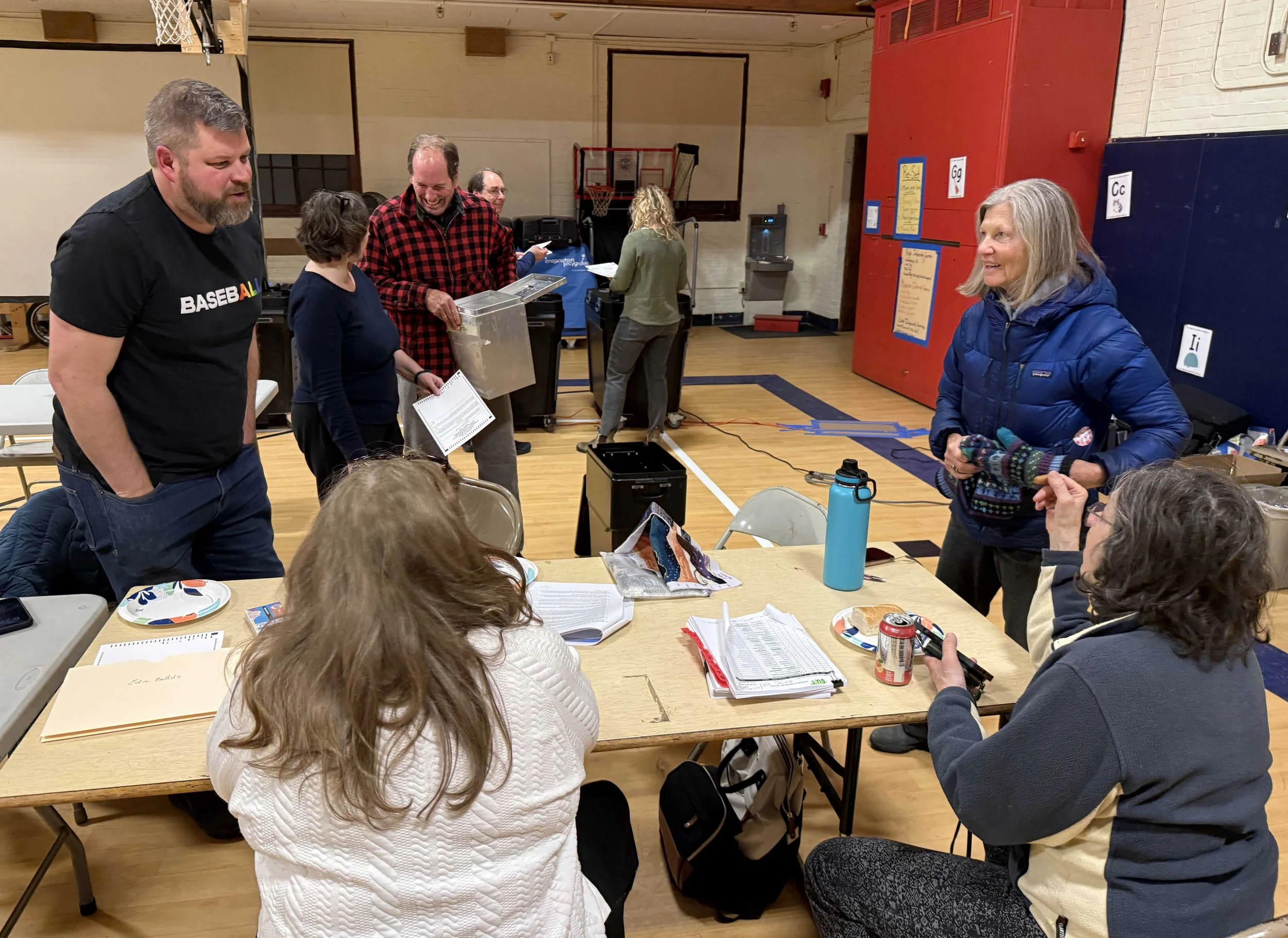   Elections officials from the Harwood communities gather in the Brookside gym for the vote count. Photo by Gordon Miller  