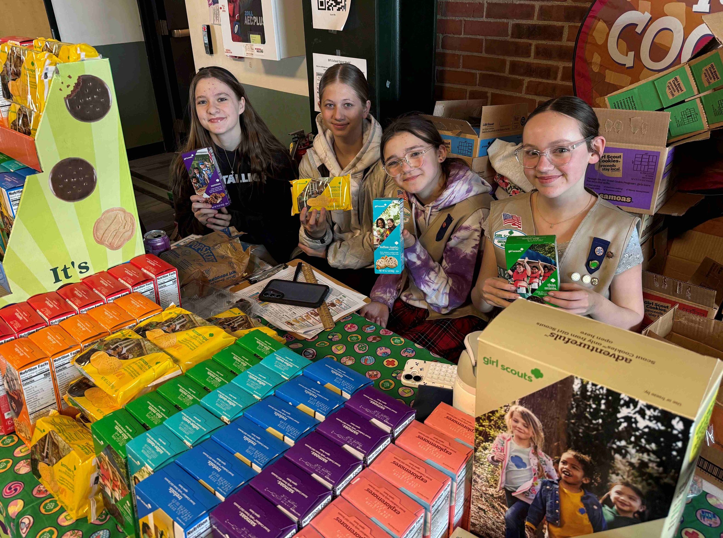   Girl Scouts stake out a key spot in the school lobby to meet cookie customers. Photo by Gordon Miller   