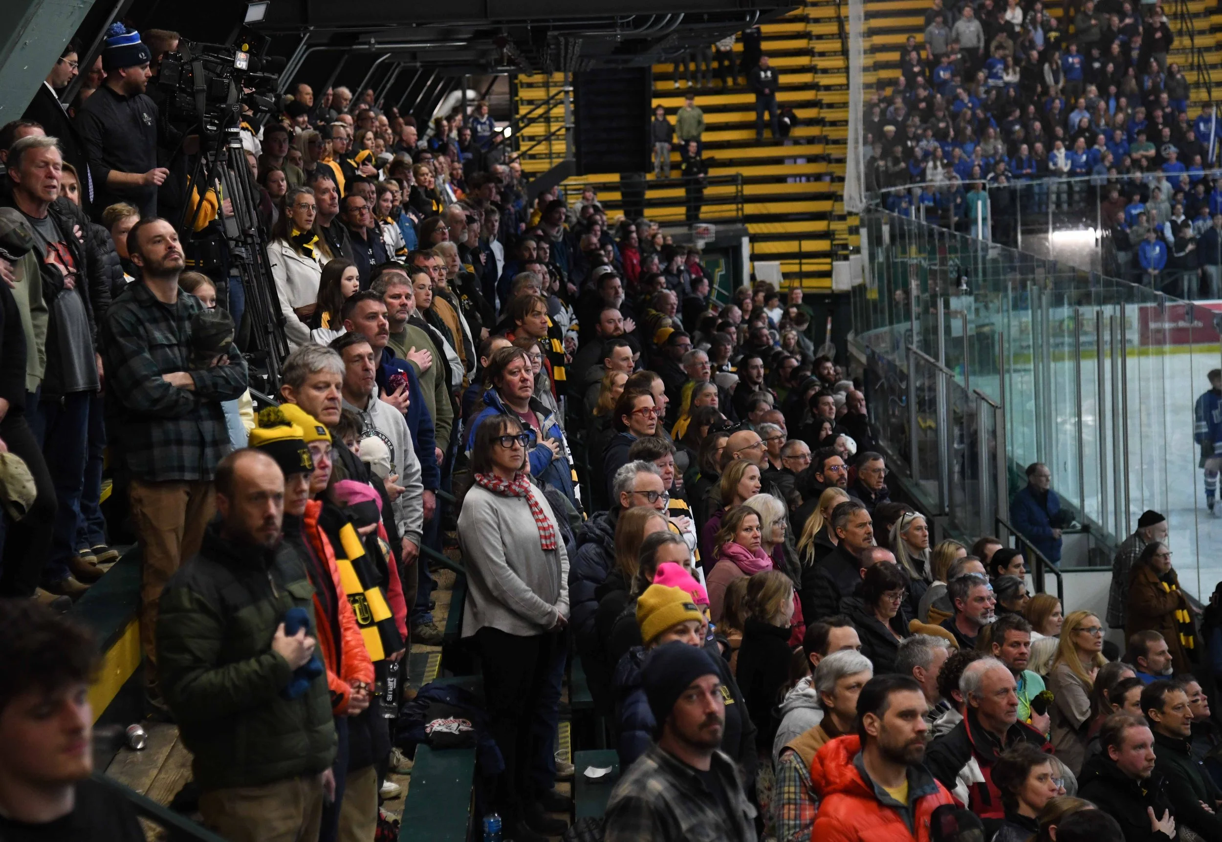   Fans stand for the national anthem.&nbsp;Photo by Gordon Miller  