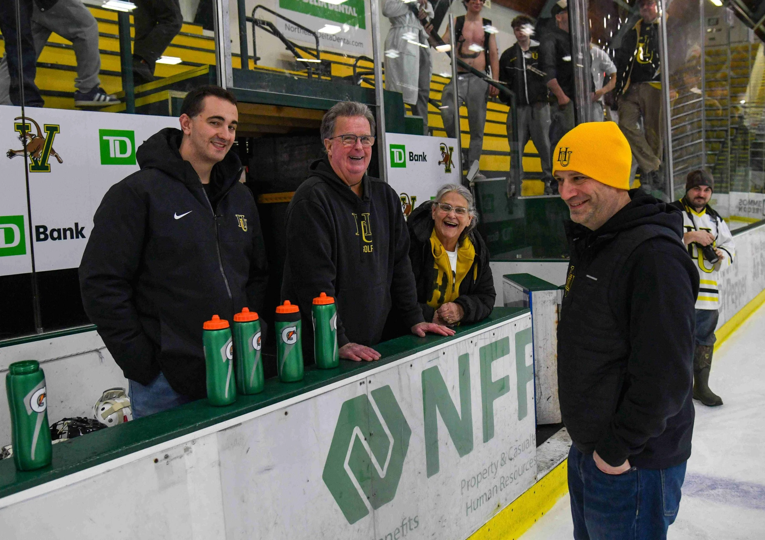  Outgoing Harwood Asst. Athletic Director Sam Grandfield, Harwood staffer and coach Brian McCarthy,&nbsp; school staff spirit "plaid" Mari Pratt, and Harwood Athletic Director Ian Fraunfelder take in the game. Photo by Gordon Miller 