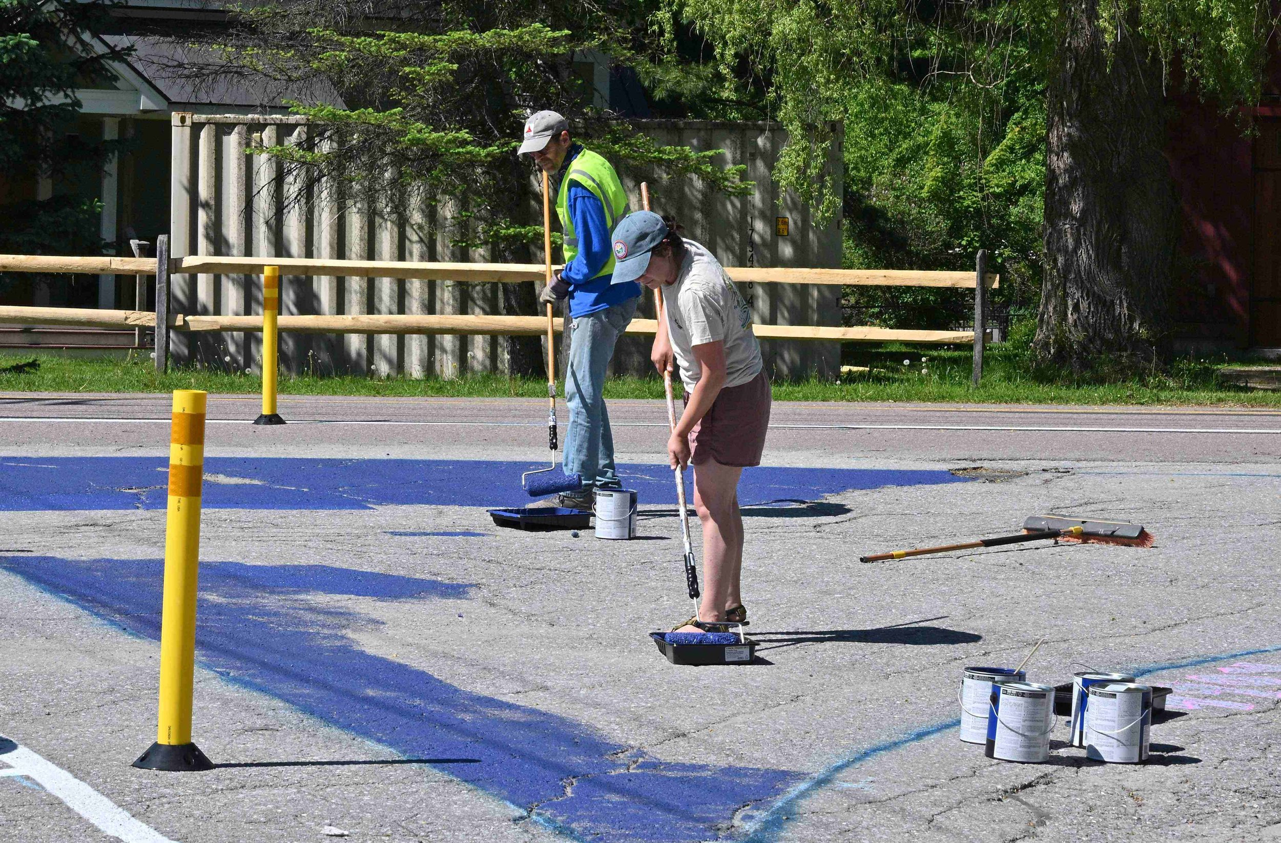  Duncan McDougall and Kati Gallagher put down the base coat of blue background paint for the mural. Photo by Gordon Miller 