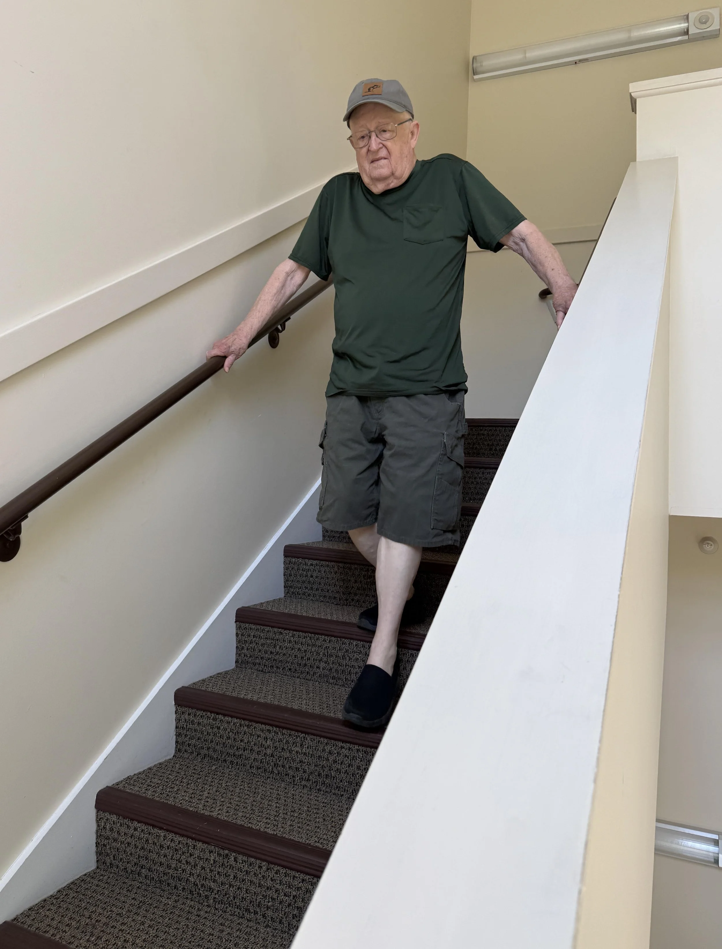  Doug Perry carefully goes down the back staircase in the Seminary Apartments. Photo by Gordon Miller 
