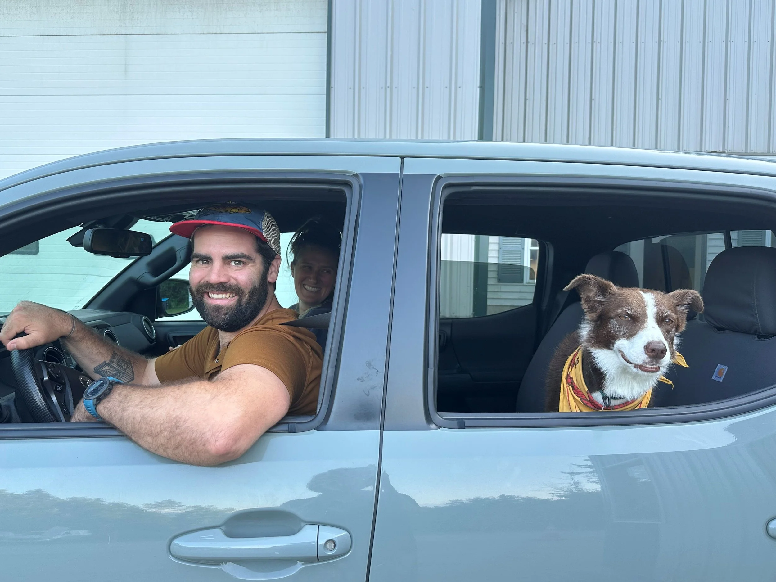   Duxbury Voters Mac Wood and Halie Cousineau with their dog Mae cast their ballots from their car.&nbsp;Photo by Lisa Scagliotti  