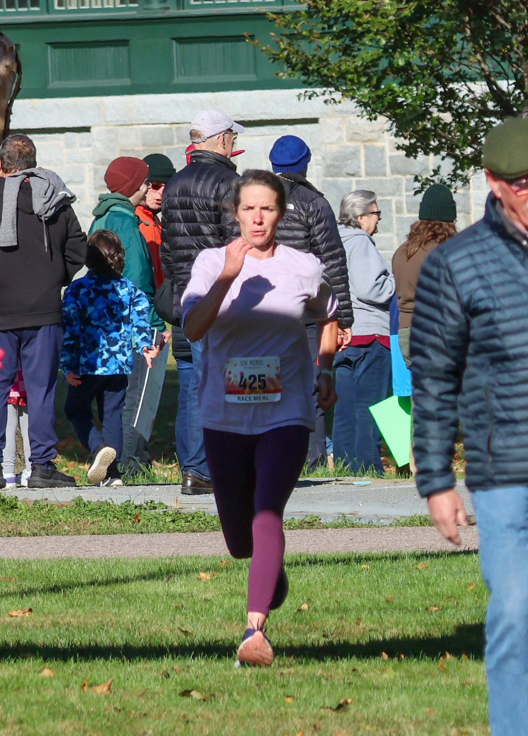   Rebekah Mangan, 42, of Cabot crosses the 5K finish in 23:48.7.&nbsp;Photo by Gordon Miller  