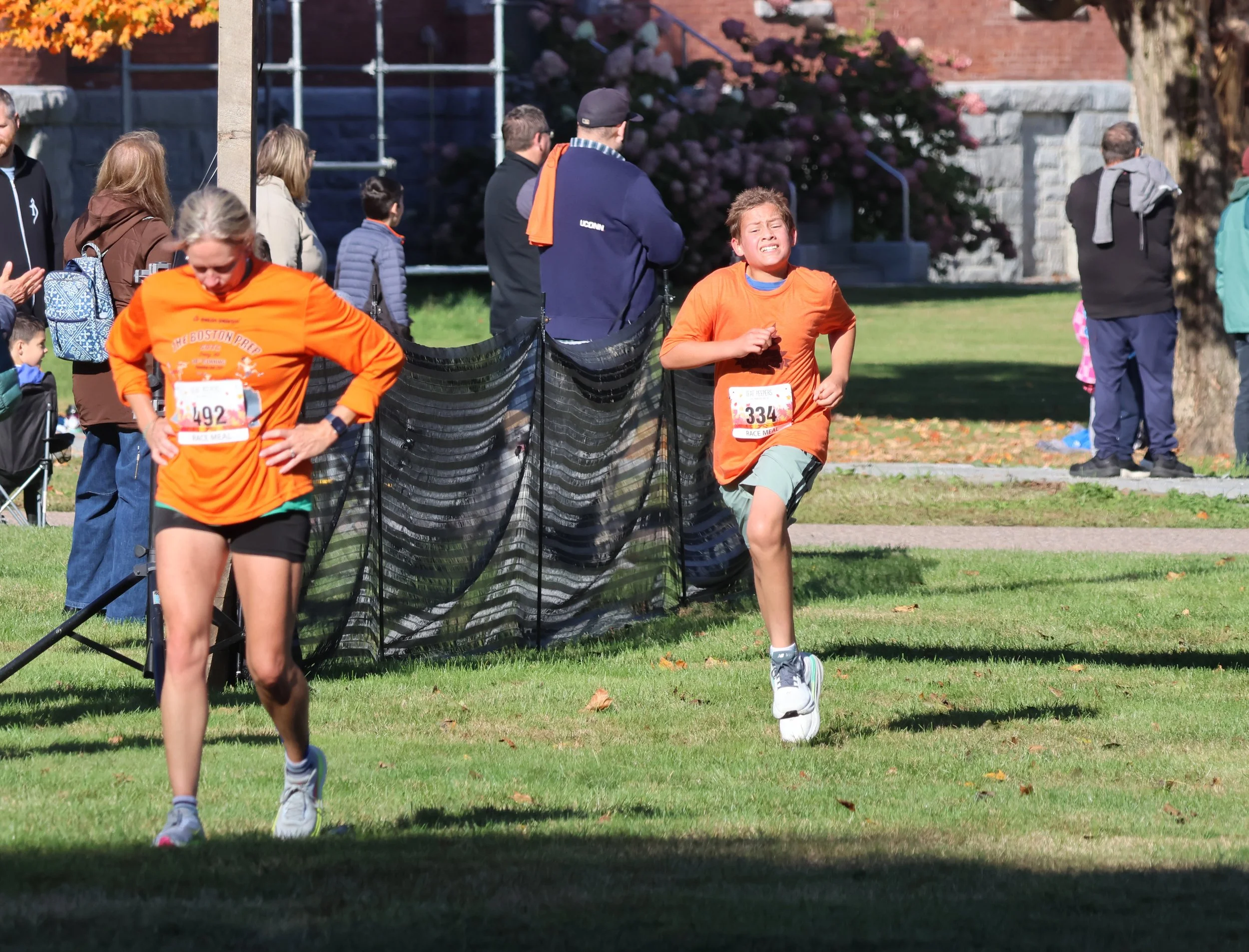   5K runners Bethany Wolfe, 47, of Burlington, finished in 25:04.5 and 12-year-old Owen Bellerose of Richmond heads to the finish in 25:16.4. Photo by Gordon Miller  