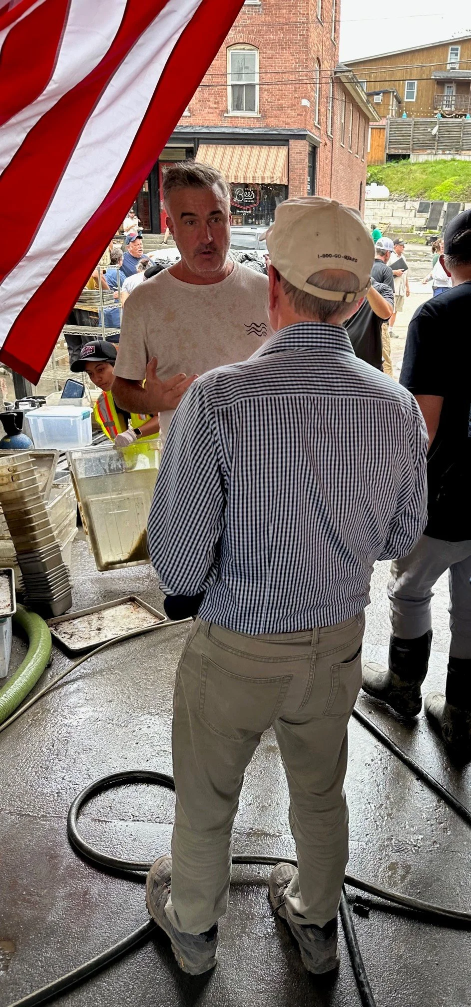 Welch tours flood zone amidst mud, cleanup, free lunch, socks, music ...