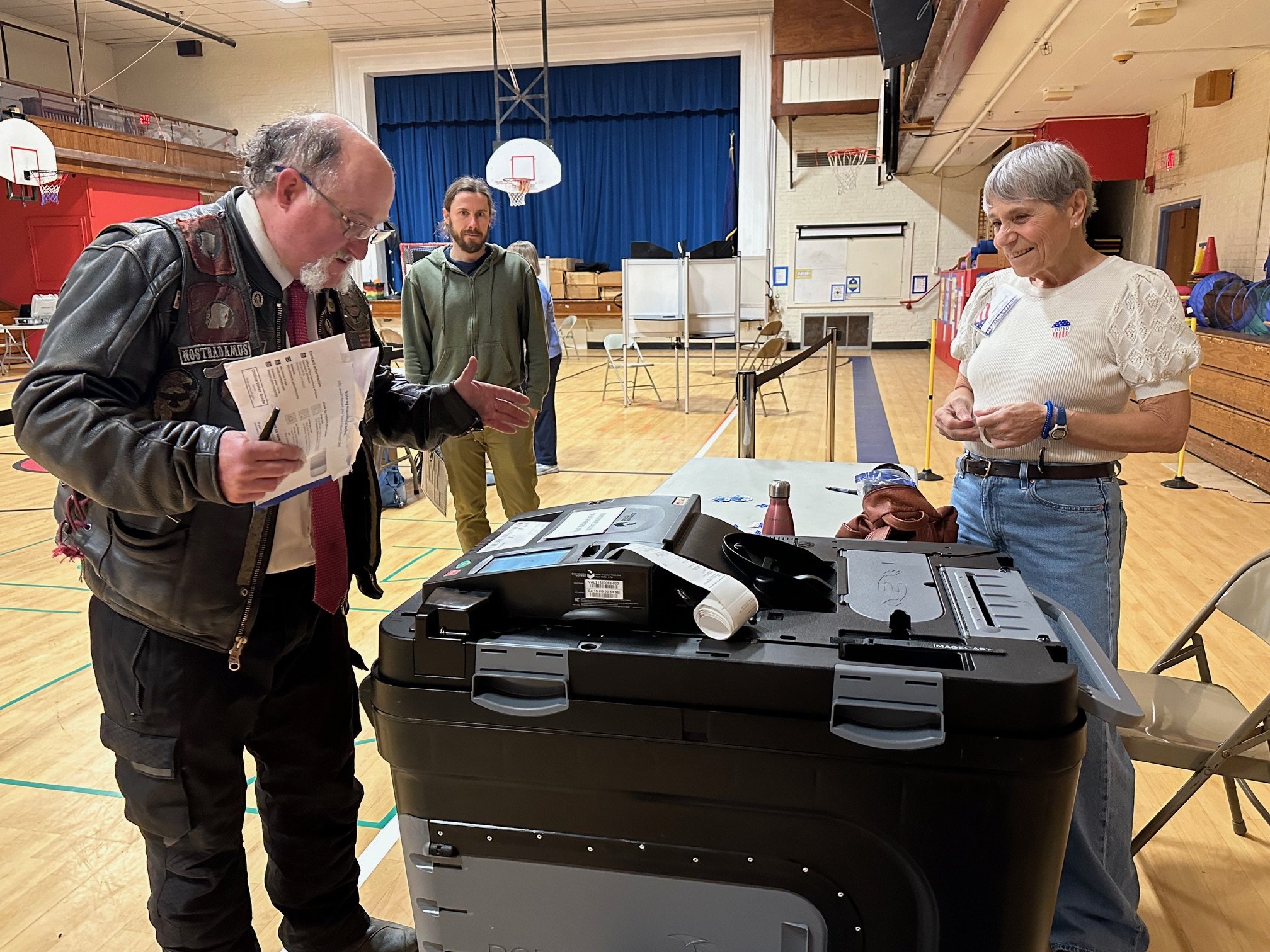Election official Linda Gravell looks on as Christopher Wood casts his ballot at Brookside Primary School. Photo by Lisa Scagliotti