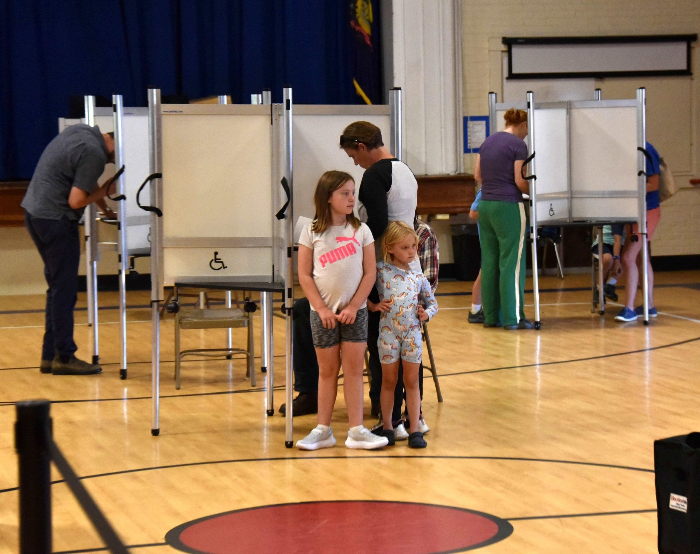 Kids along at the polls wait while parents vote. Photo by Gordon Miller