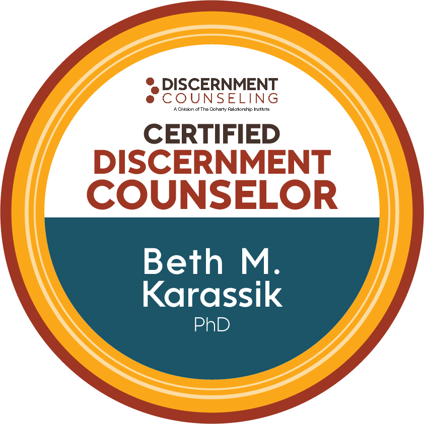 Badge indicating certification as a discernment counselor for Beth M. Karassik, PhD, by Discerment Counseling, a division of The Ooherry Relationship Institute.
