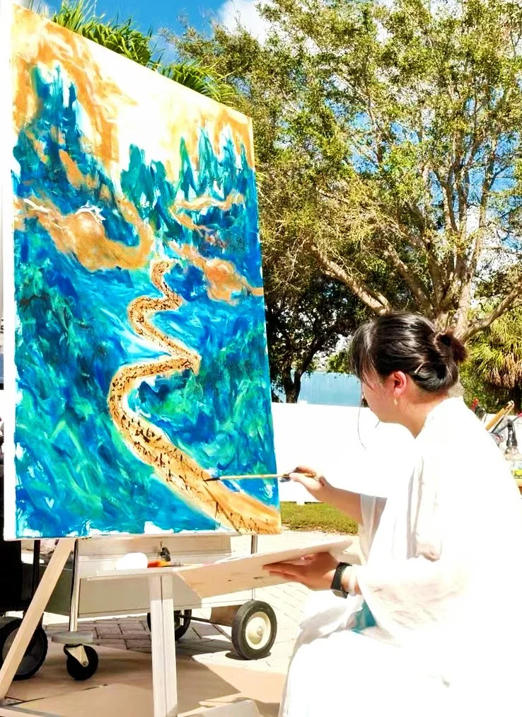 Woman painting a landscape on canvas outdoors, with trees and blue sky in the background.