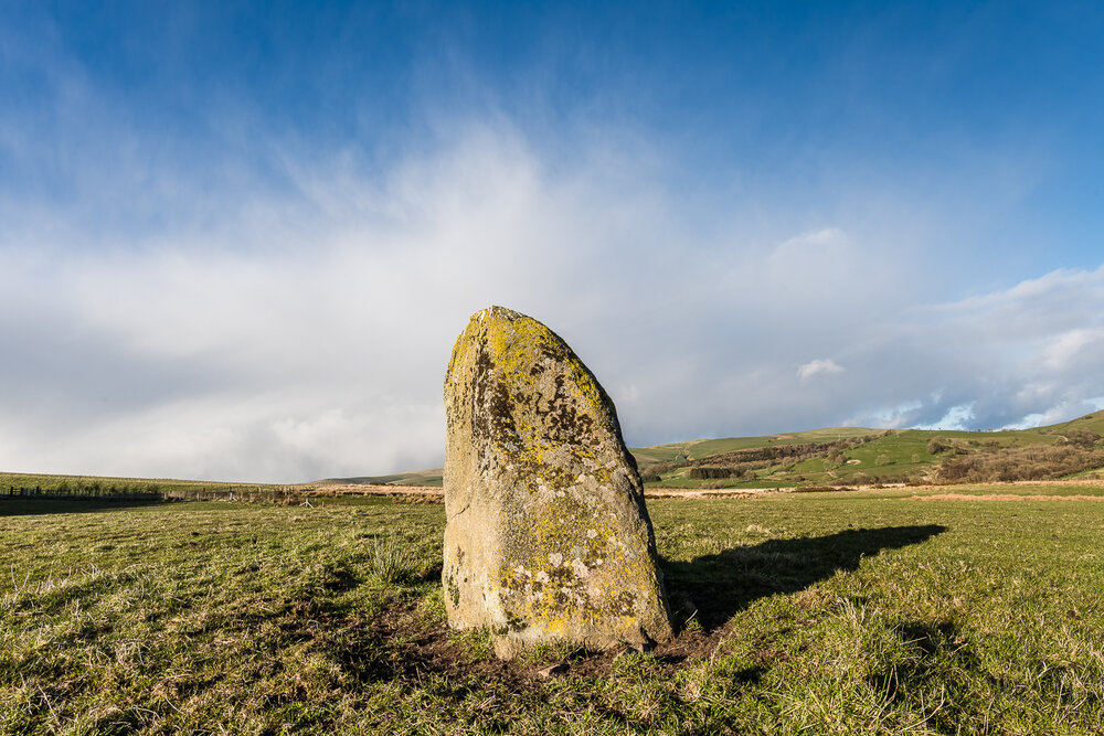 Cwm Maerdy standing stone, with an approaching snowstorm
