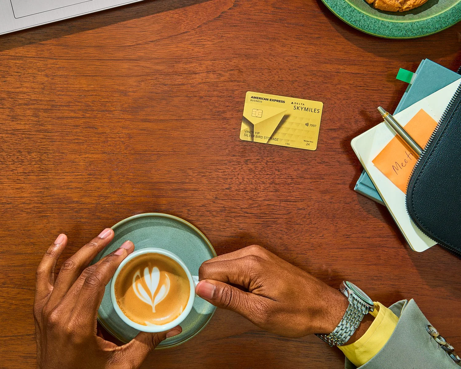 American Express and Delta Gold card photographed with coffee and travel essentials.