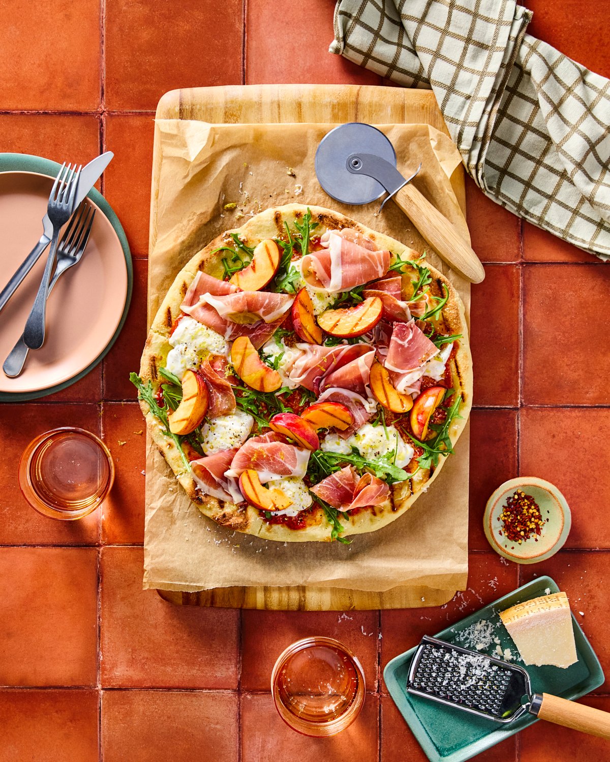 Grilled prosciutto peach pizza photographed on a colorful set for National Pork Board.