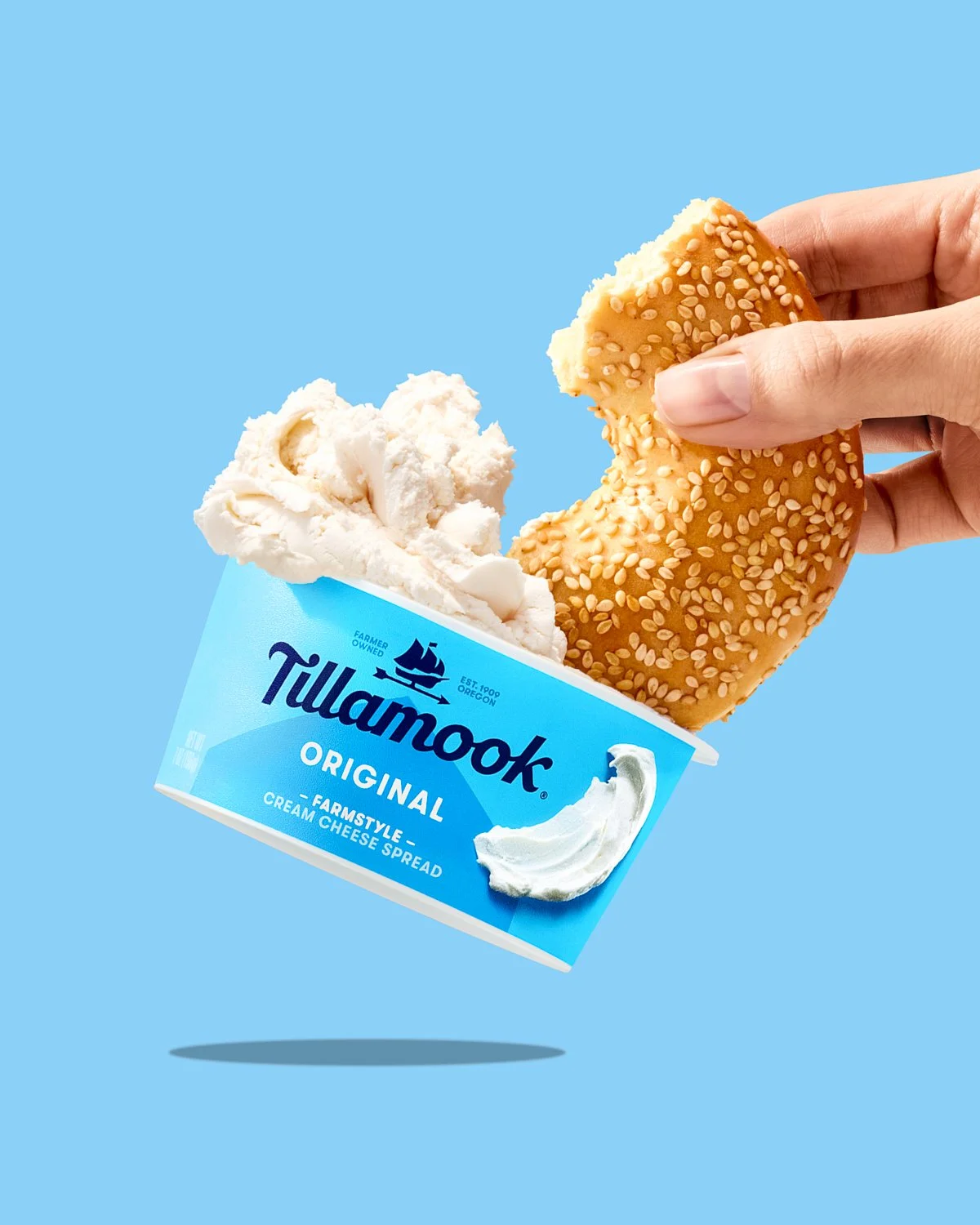Tillamook cream cheese bagel with hand